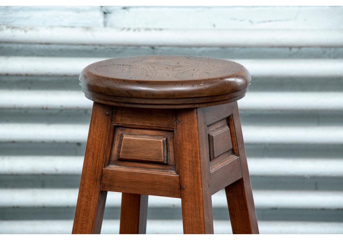 A carved hardwood pedestal for sculpture display. In an angular form wider at the top, with splayed square legs, and carved apron and skirt stretcher panels. Thick round top, the sculpture stand is very sturdy with good weight.
Measures: Height
