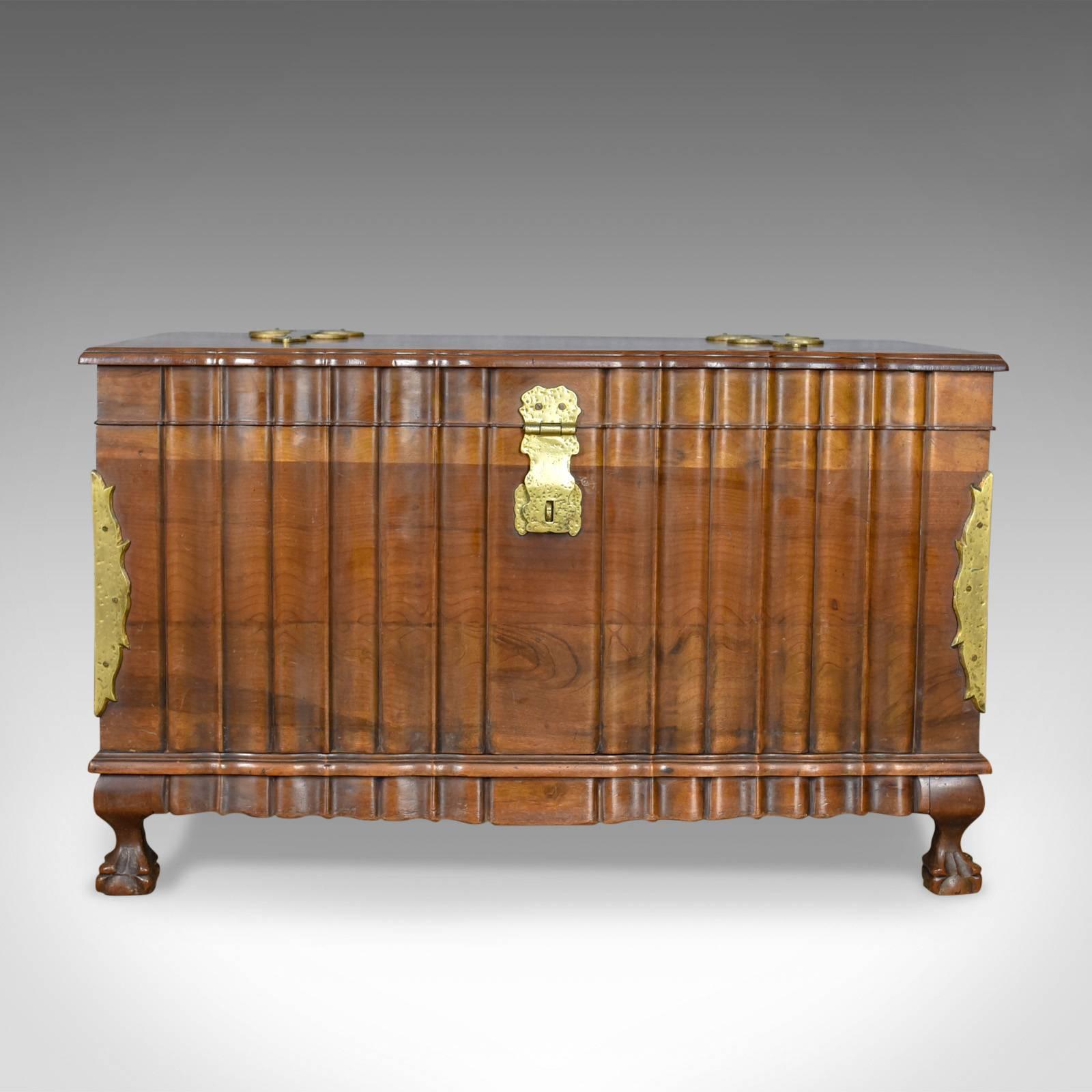 This is an Asian hardwood trunk, a bronzed metal mounted chest or coffer dating to the late 20th century.

Of quality craftsmanship and stock
Attractive variegated grain interest in caramel hues
In rippled form dressed with hammered bronzed