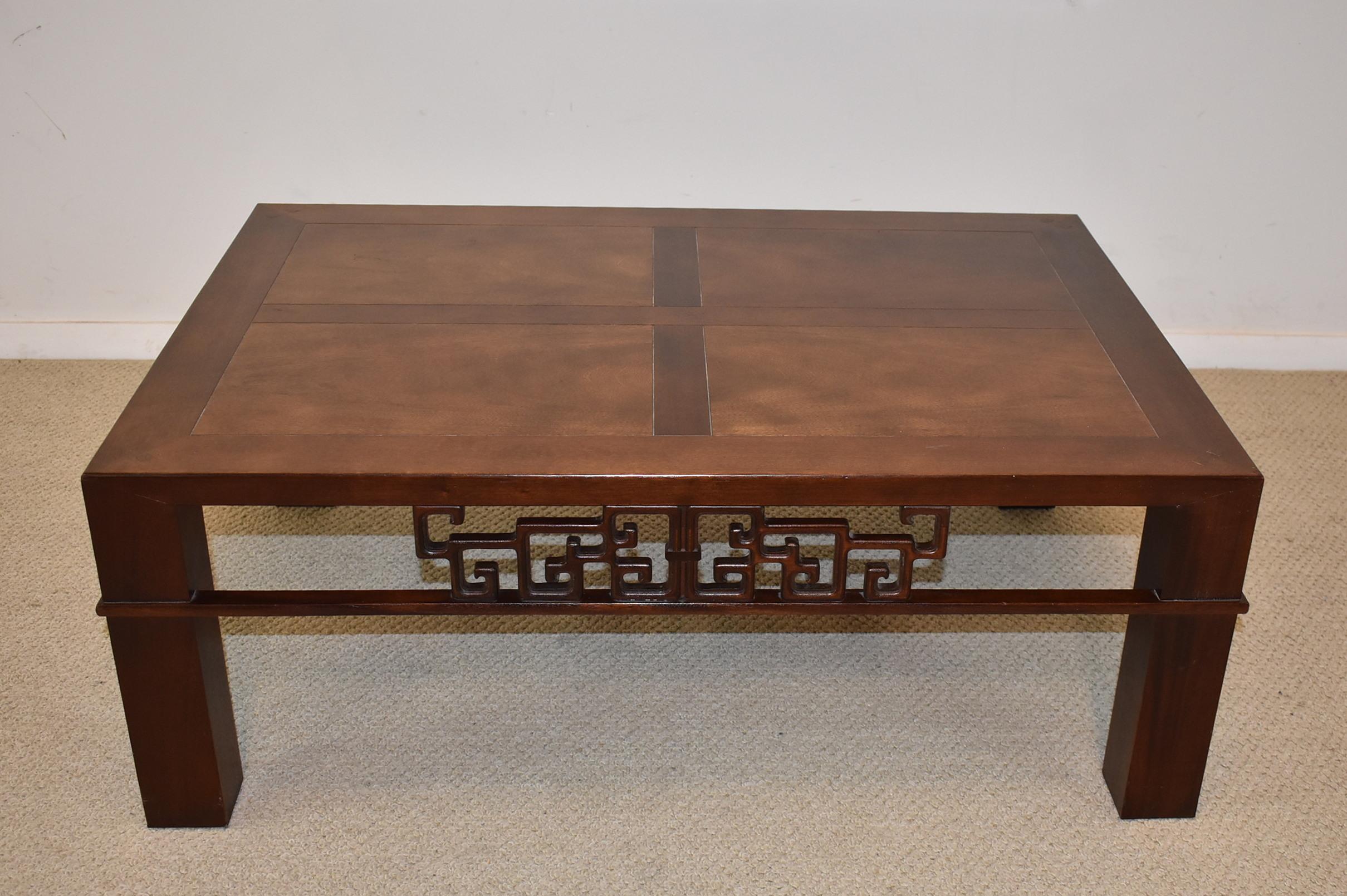 Asian style walnut coffee table by Baker Furniture. Decorative carved openwork side details. Very nice condition. Dimensions: 28.5