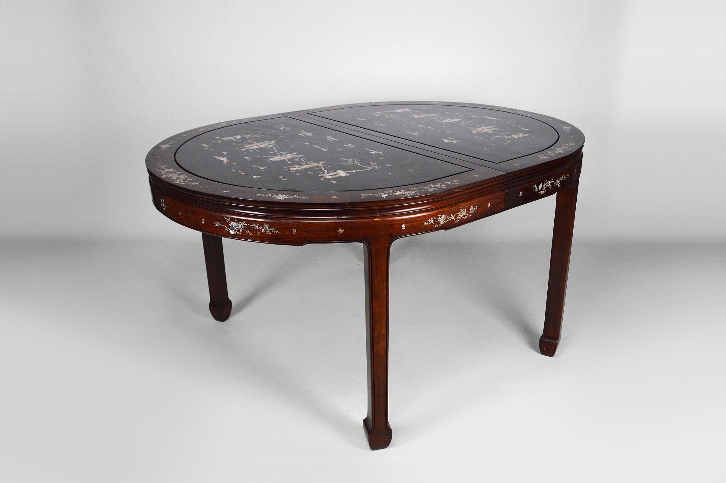 Important Asian dining table with marquetry.

2 Extensions also inlaid.

Beautiful marquetry representing life scenes with characters (musicians) with floral (flowers) and animal (birds, insects, butterflies, dragonflies) elements.

Very good