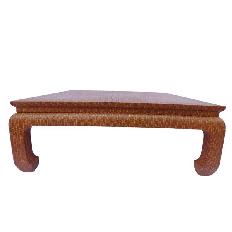 An Asian inspired raffia wrapped square coffee table from Baker with Ming style legs and curved feet.  The rich textured light brown table adds a contemporary spin with vintage style