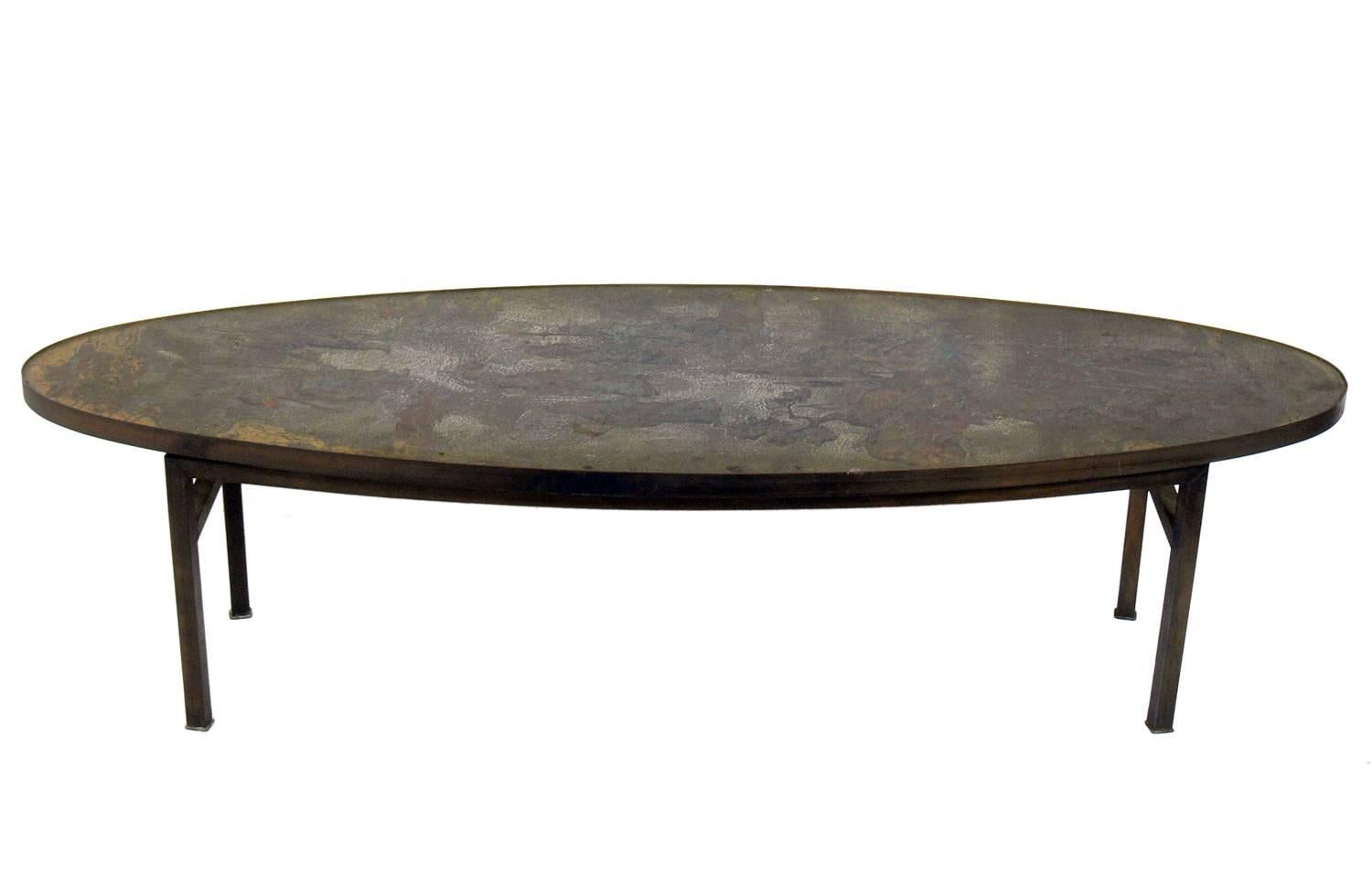 Asian inspired coffee table, made by Phillip and Kelvin Laverne, American, circa 1960s. Long surfboard shape with richly patinated Asian inspired decorations to the tabletop.