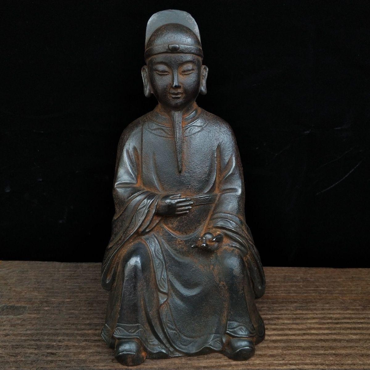 Asian Iron Sitting Ksitigarbharaja Buddha Statue with A Magic Ball in Hand, Kṣitigarbha is often depicted in religious art and texts as a compassionate and determined figure committed to saving sentient beings, especially those suffering in the hell