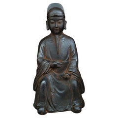 Statue de Bouddha Ksitigarbharaja assise en fer asiatique avec une boule magique à la main