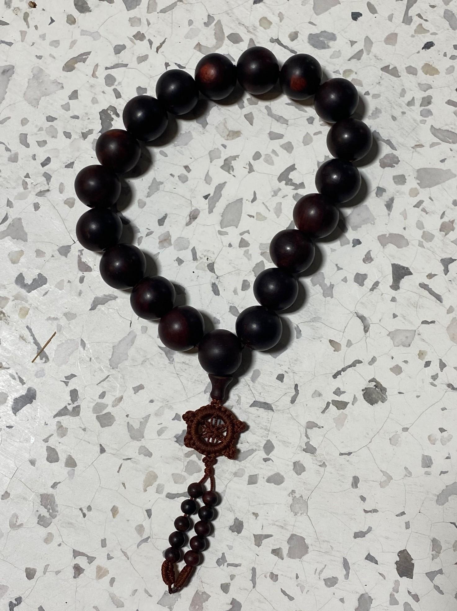 A wonderful Asian (likely Japanese, Chinese or Vietnamese) dark natural Agarwood prayer bead Buddhist rosary bracelet. The piece has a beautiful rich color and glowing organic patina to it. Agarwood beads are used in religious ceremonies as a rosary