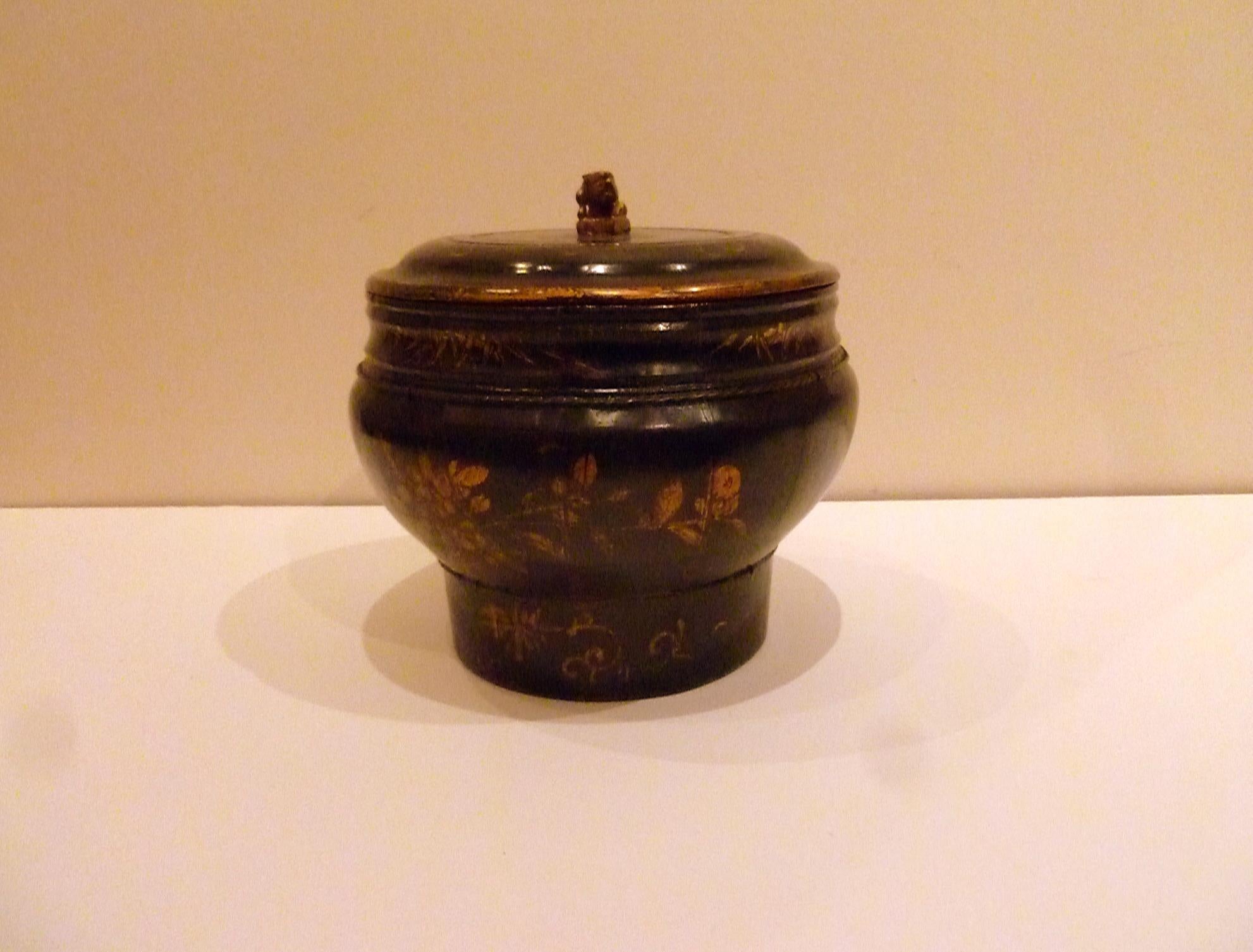 Asian Lacquer Dessert Container with Cover.  Hand painted gilt floral motif on the body and the cover with carved foo lion finial on the cover.
