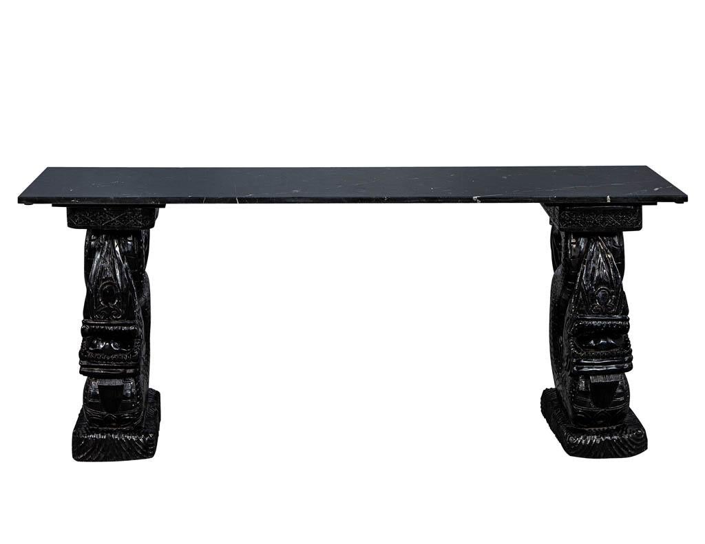Asian marble-top console with carved dragon pedestals. Original 1920s piece with new black marble top.