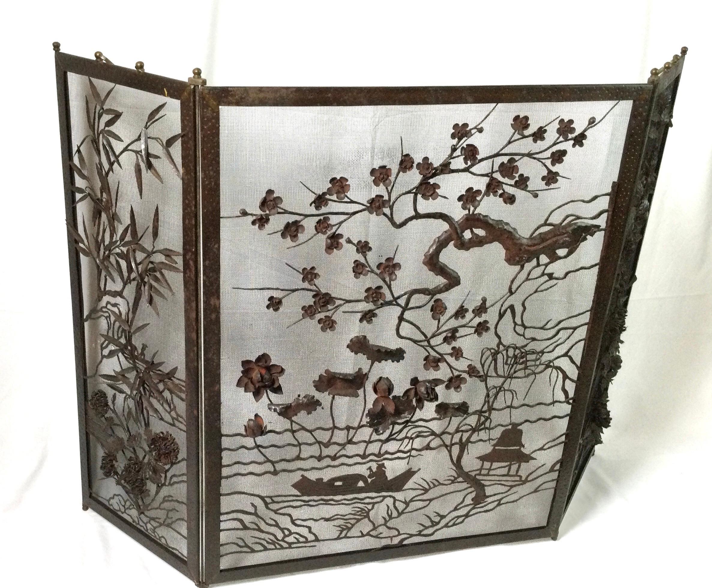 Late 19th century mixed metal fire screen with three panels. Asian motif with flowers, pagodas, bamboo shoots and exotic trees designed on all three panels. Nice high relief that will just dance with a fire behind it. Size: 54