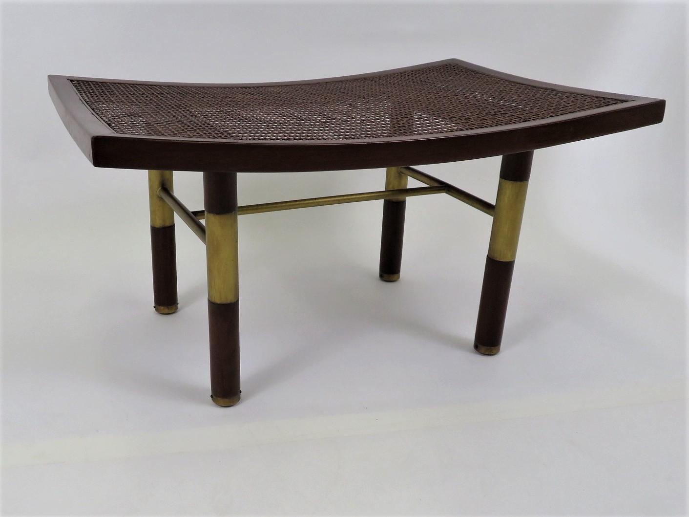 REDUCED FROM $1,750...From the 1950s and Michael Taylor, this Far East Collection Bench has a caned top and a pagoda form with turned up ends and brass stretchers and feet. Re-caned and it has been refinished. Some imperfections in the top wood by