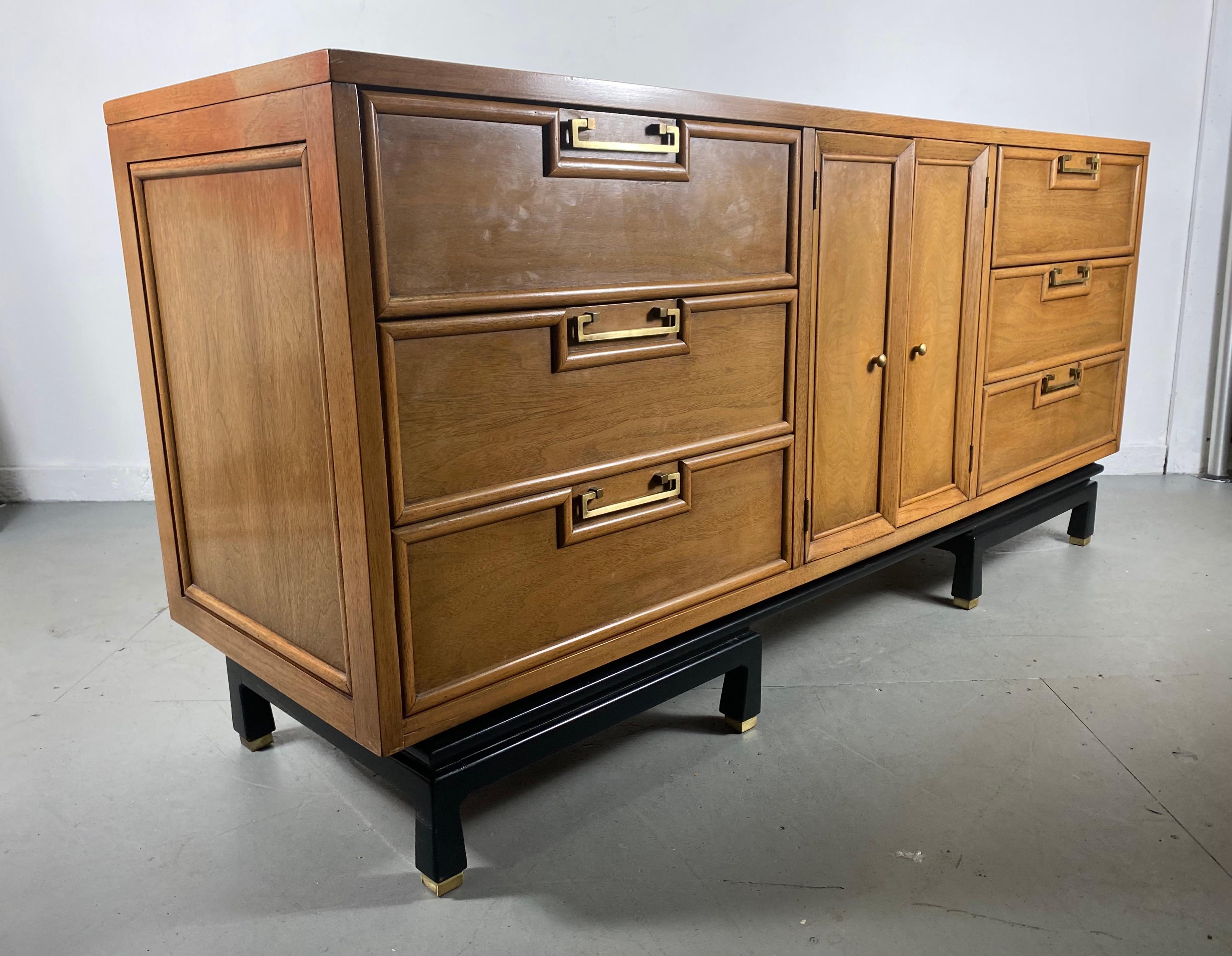 Stunning Asian modern 9 drawer dresser, mahogany / black lacquer and brass by American of Martinsville, beautifully grained mahogany construction. Stylized black lacquer base with brass feet, brass drawer pulls. Superior quality and construction.