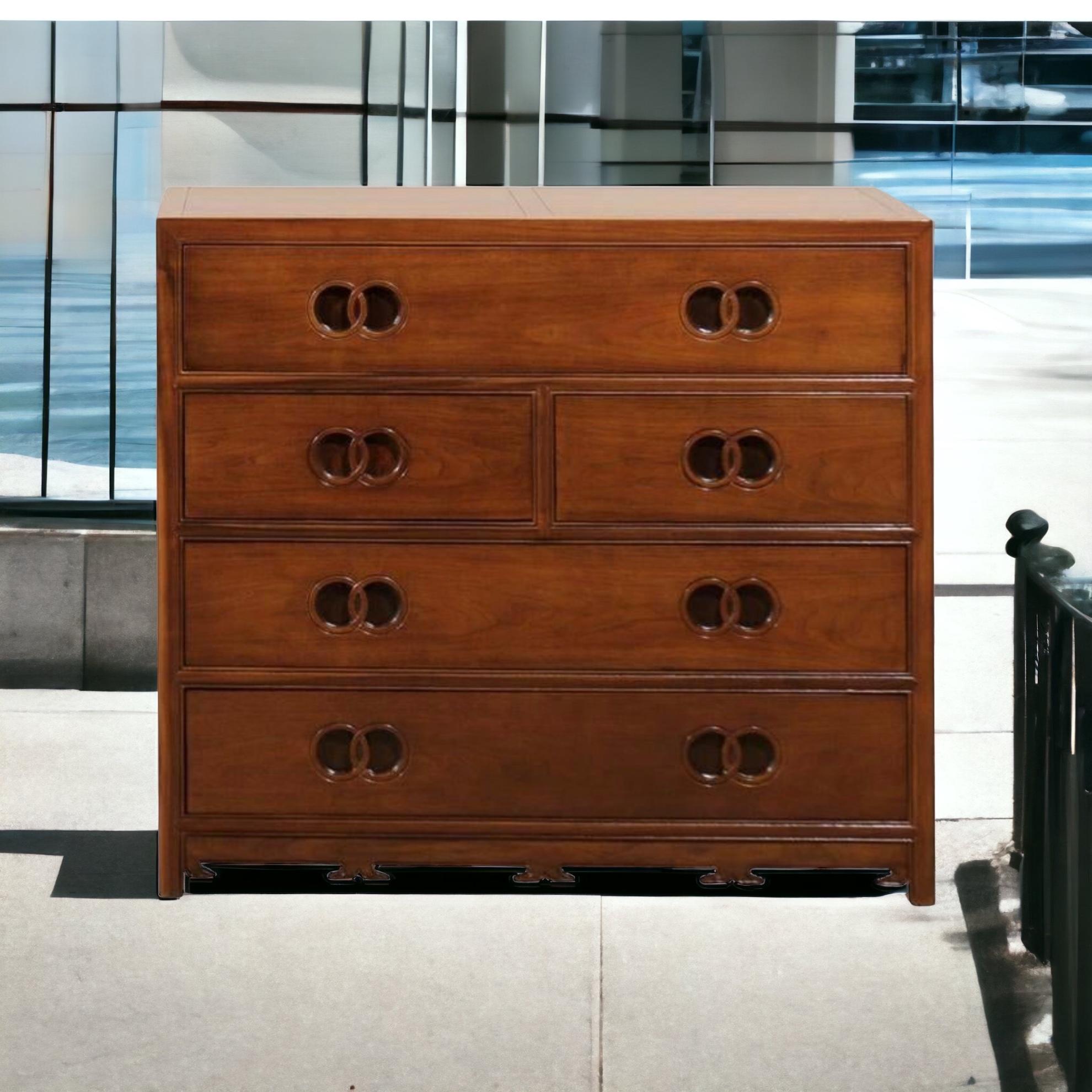 This is a modern bachelor’s chest with Asian styling designed by Michael Taylor for Baker Furniture Company. It is carved mahogany. The piece is marked and in very good condition.
