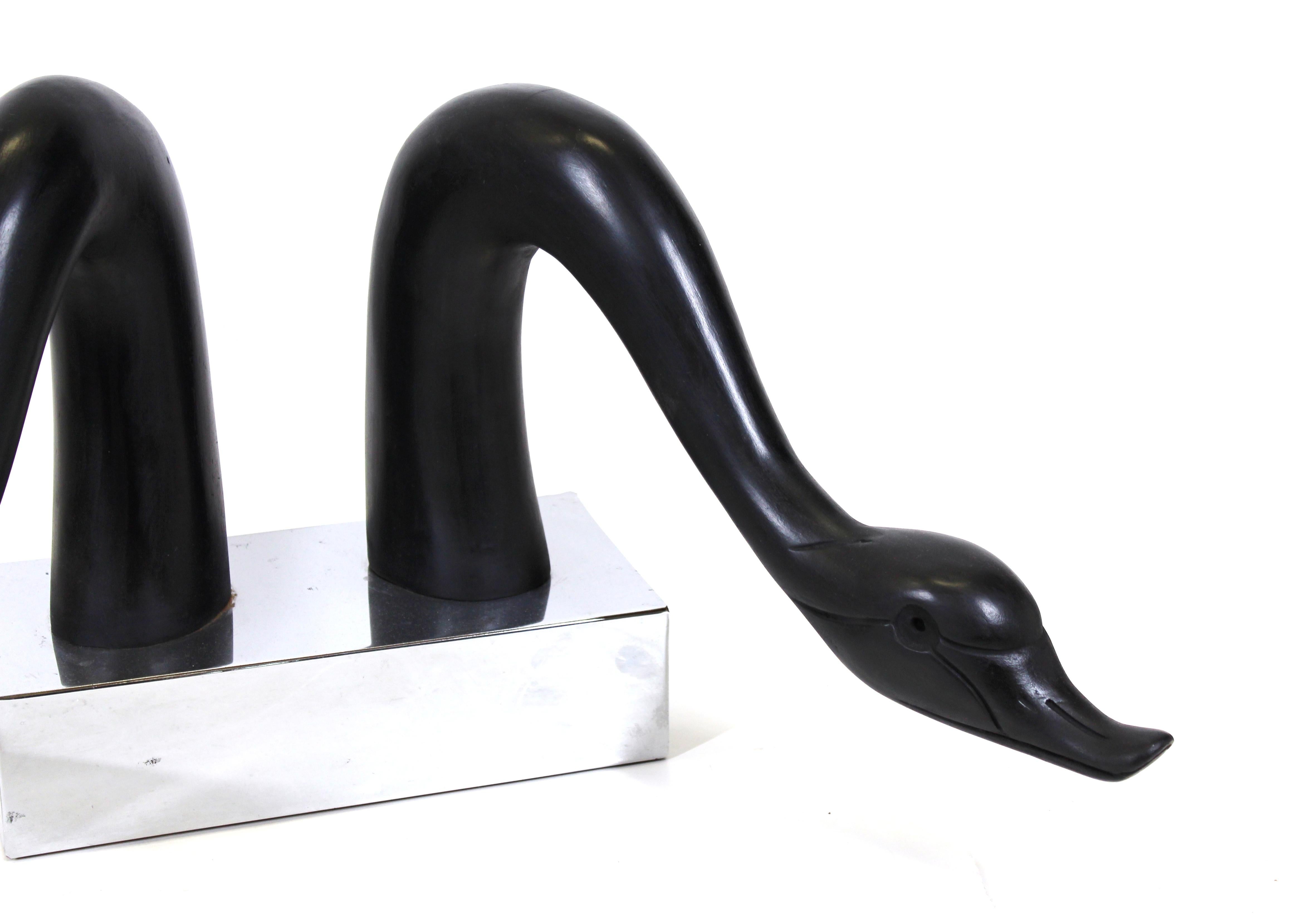 Asian Modern style pair of ebonized swan or goose heads mounted on a chromed base.