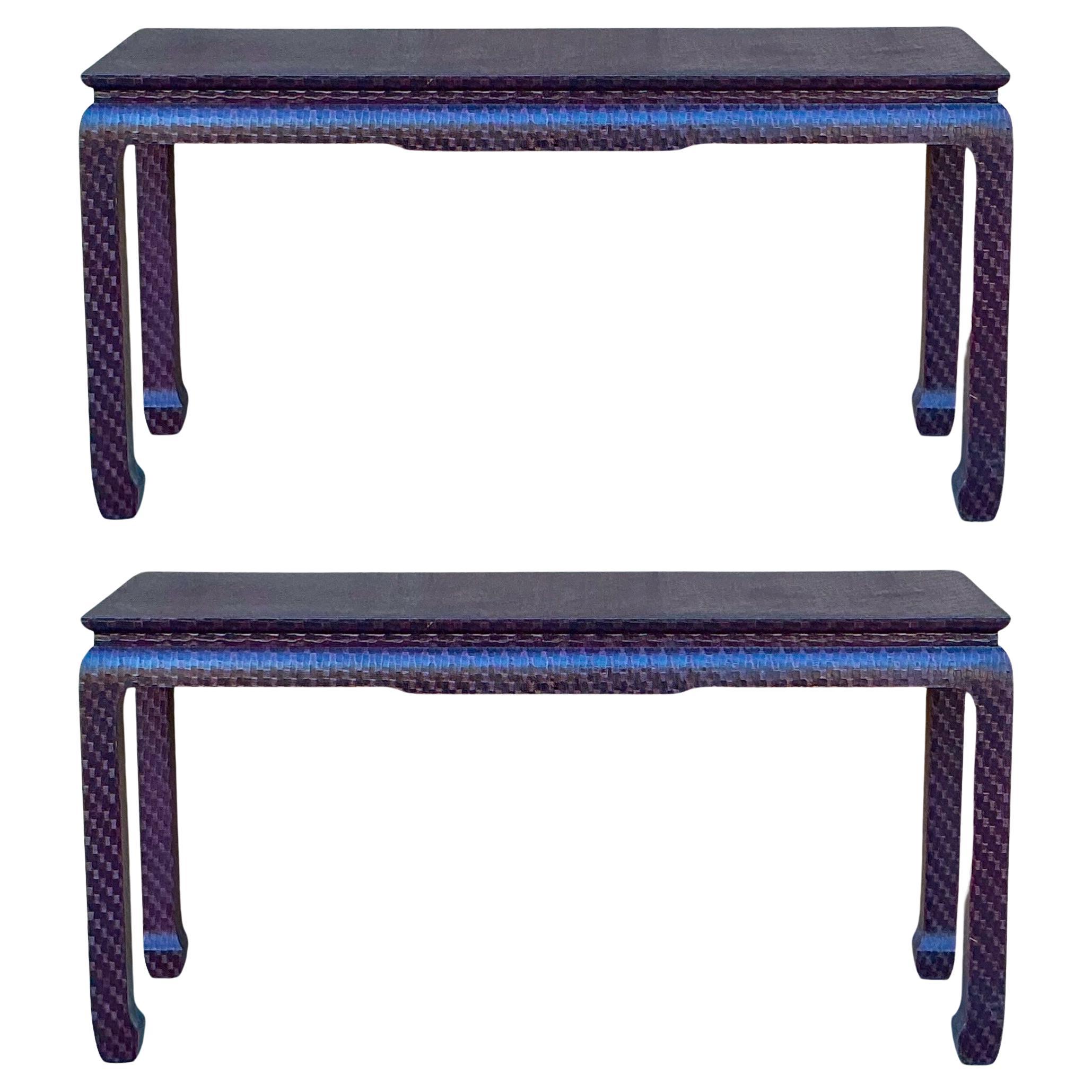 This is a pair of Ming style grasscloth wrapped console tables attributed to Baker Furniture Company. They both are in very good condition. The textured grasscloth is a deep almost burgundy. A rare find to get a pair!