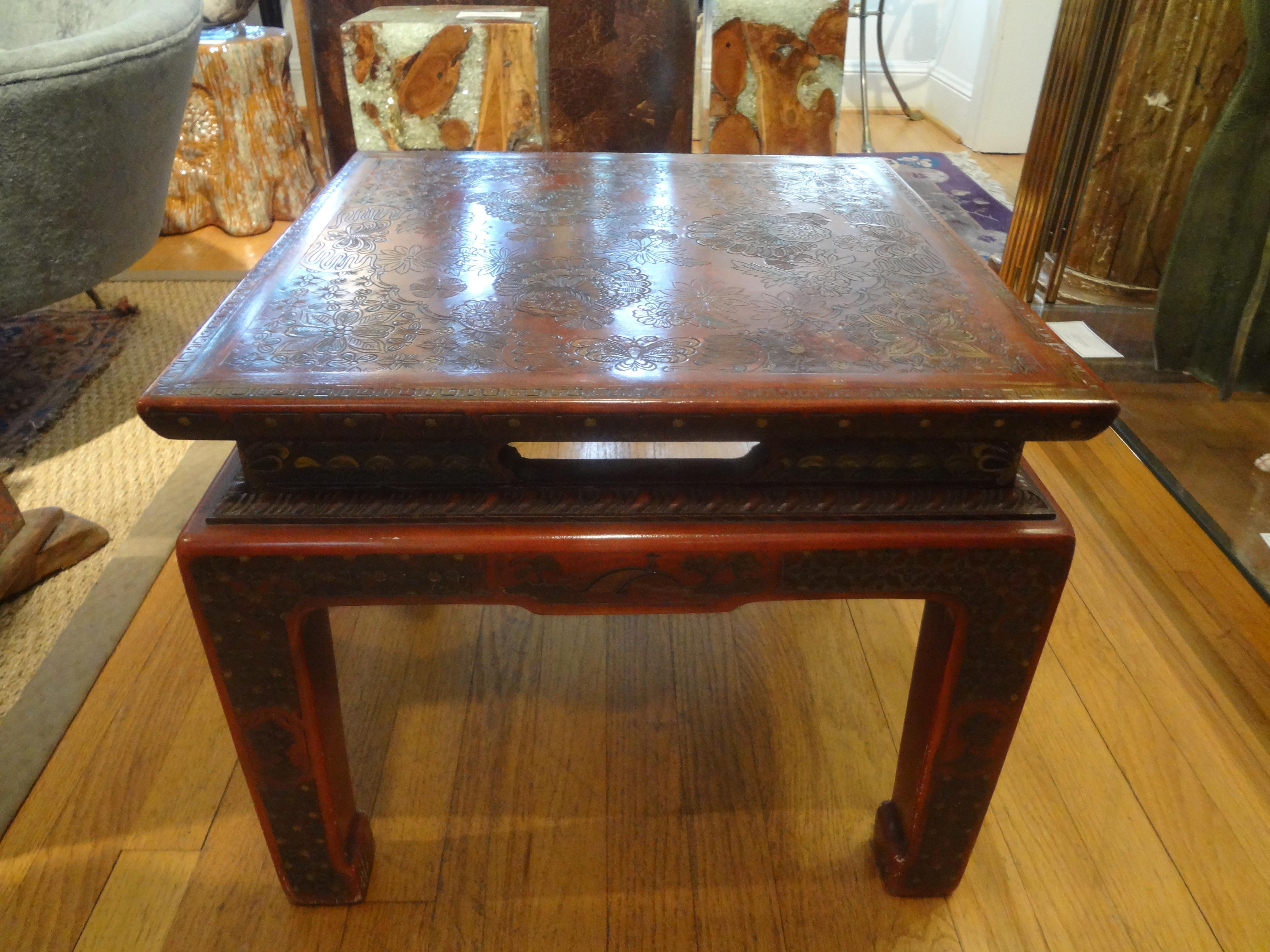 Asian Modern John Widdicomb square lacquered table with incised decoration. This gorgeous low table or end table is lacquered a Chinese burgundy / red with incised floral and butterfly decoration on top and all sides.