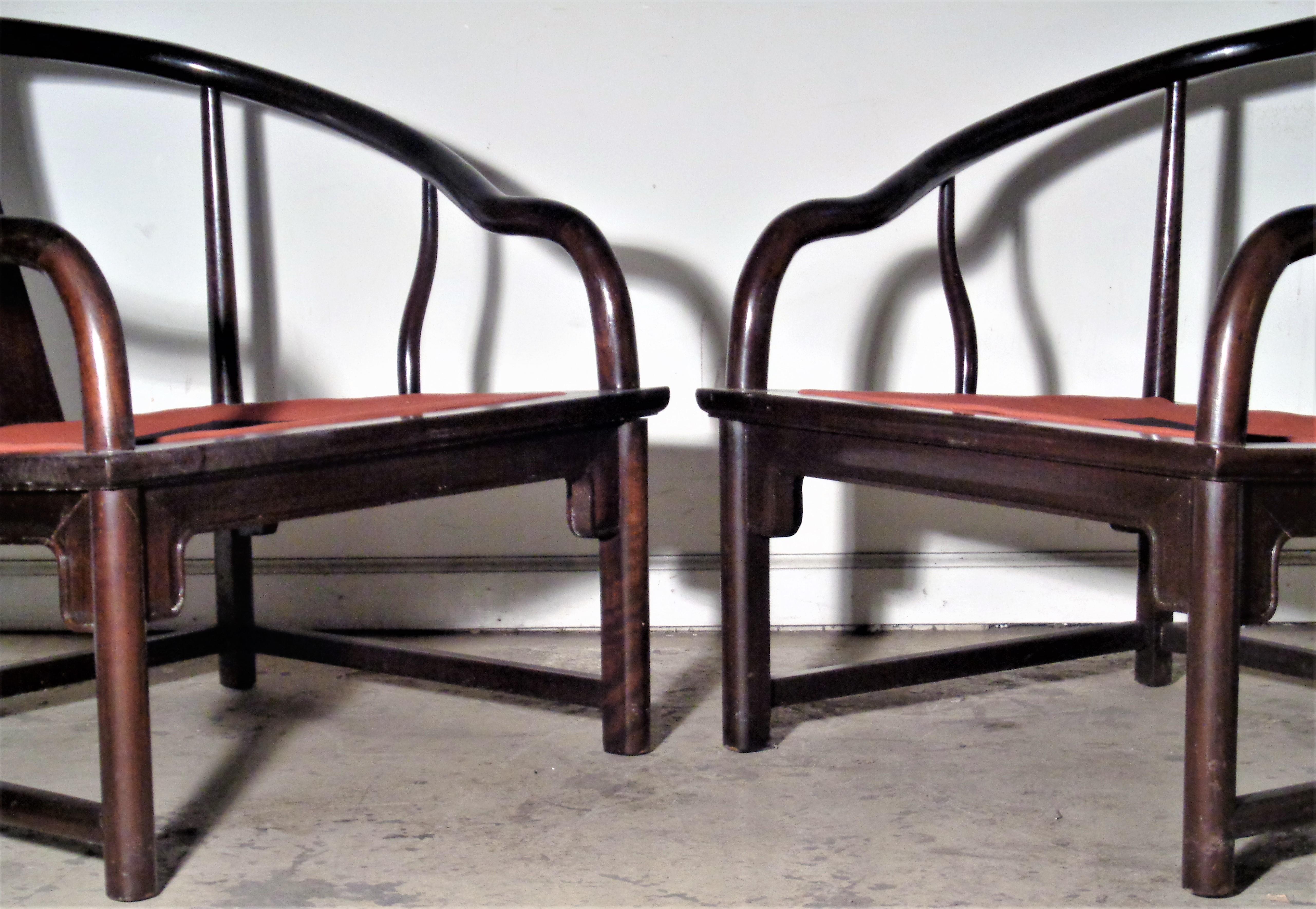 Pair of Asian Modern walnut lounge chairs with original ultra-suede type upholstered seat and back cushions. In the style of Michael Taylor - Far East Collection for Baker Furniture. Circa 1960. Measure 28 1/2 inches high x 26 inches deep x 31