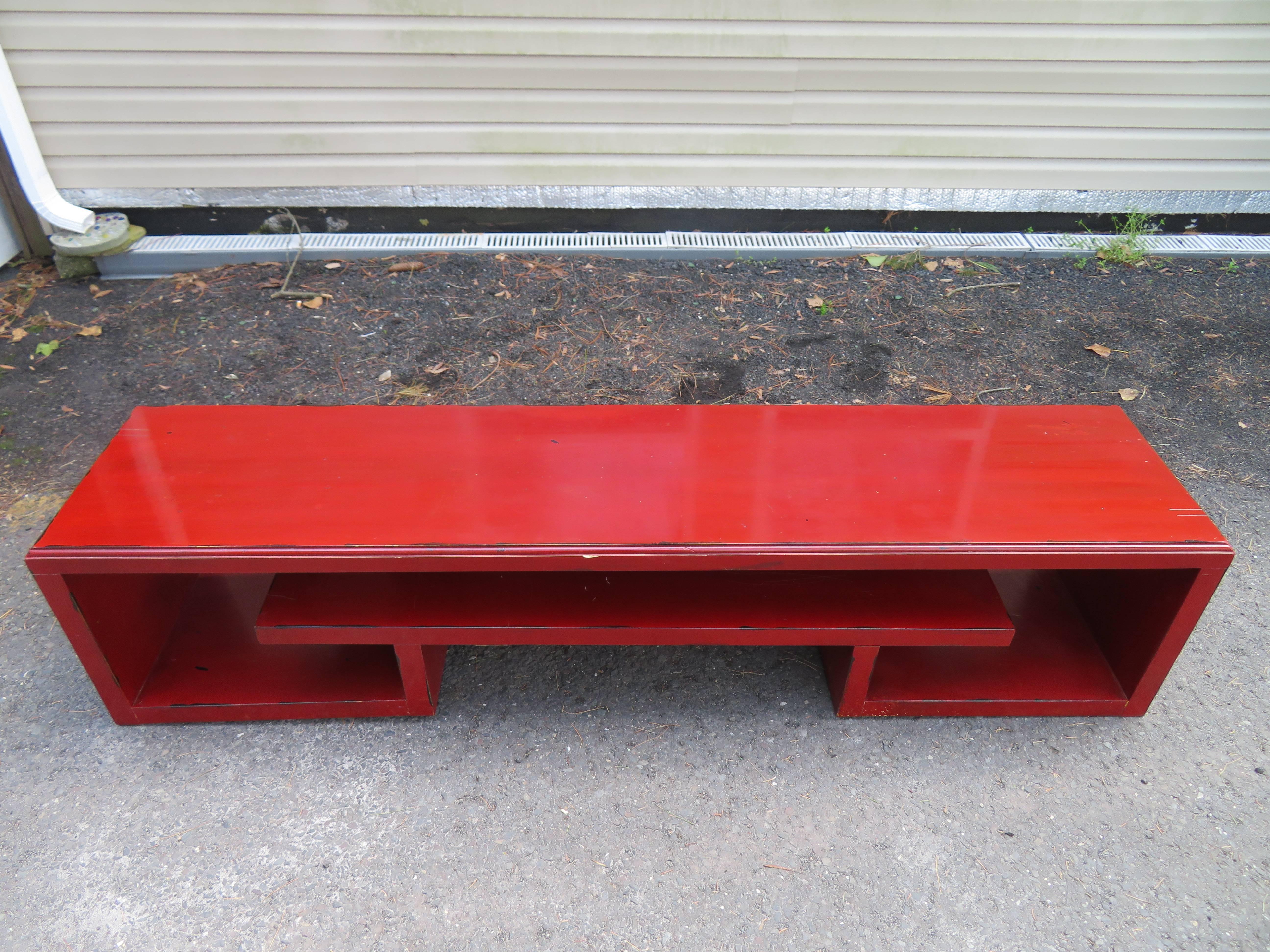 Interesting Paul Frankl Asian modern long cinnabar lacquered bench. This piece is in vintage condition and does show it's age-we recommend a new lacquer job. This piece is made of solid wood and is well constructed and heavy- would look amazing with