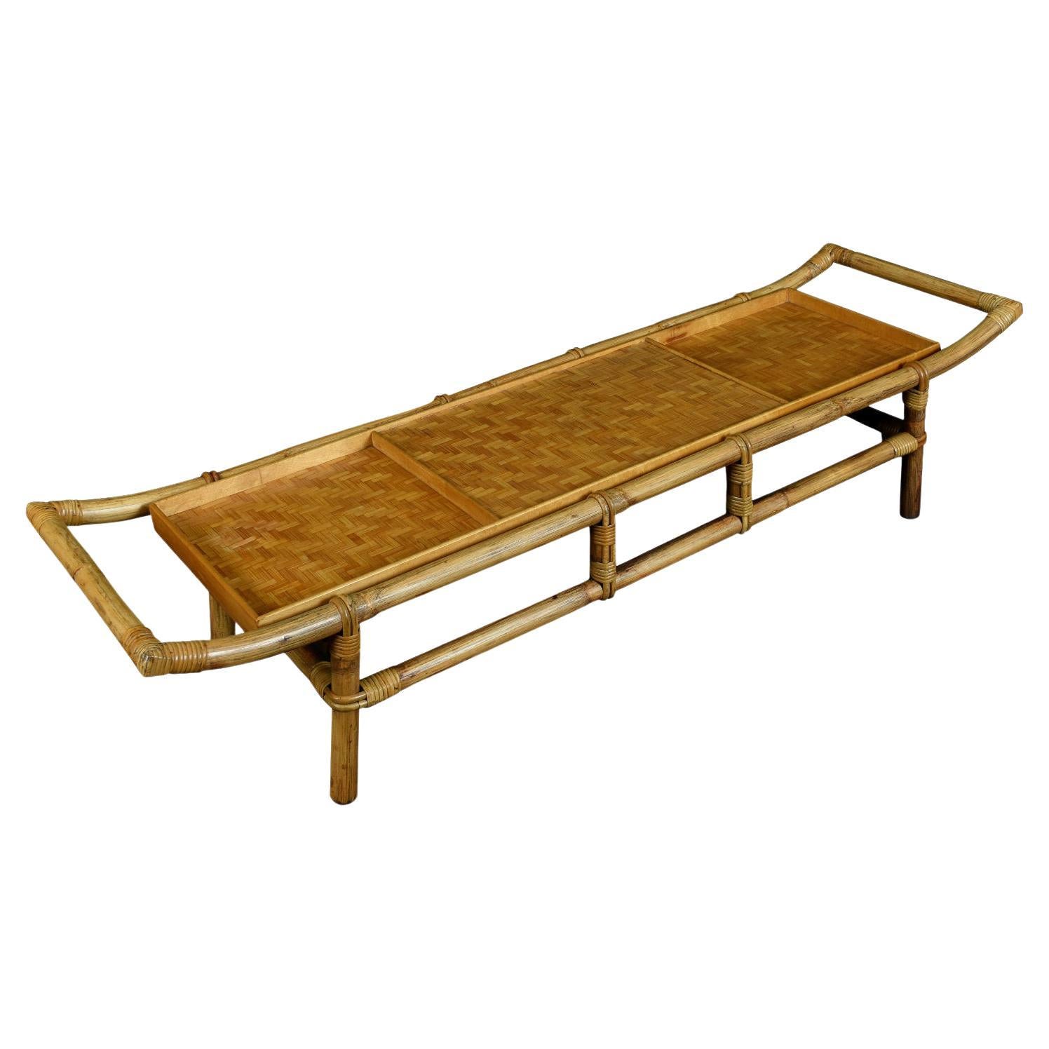 This unique bamboo and rattan pagoda style coffee table was designed by John Wisner for Ficks Reed, circa 1950s. John Wisner graduated from Parsons School Of Design in 1935 and designed for both private clients, and corporate clients including
