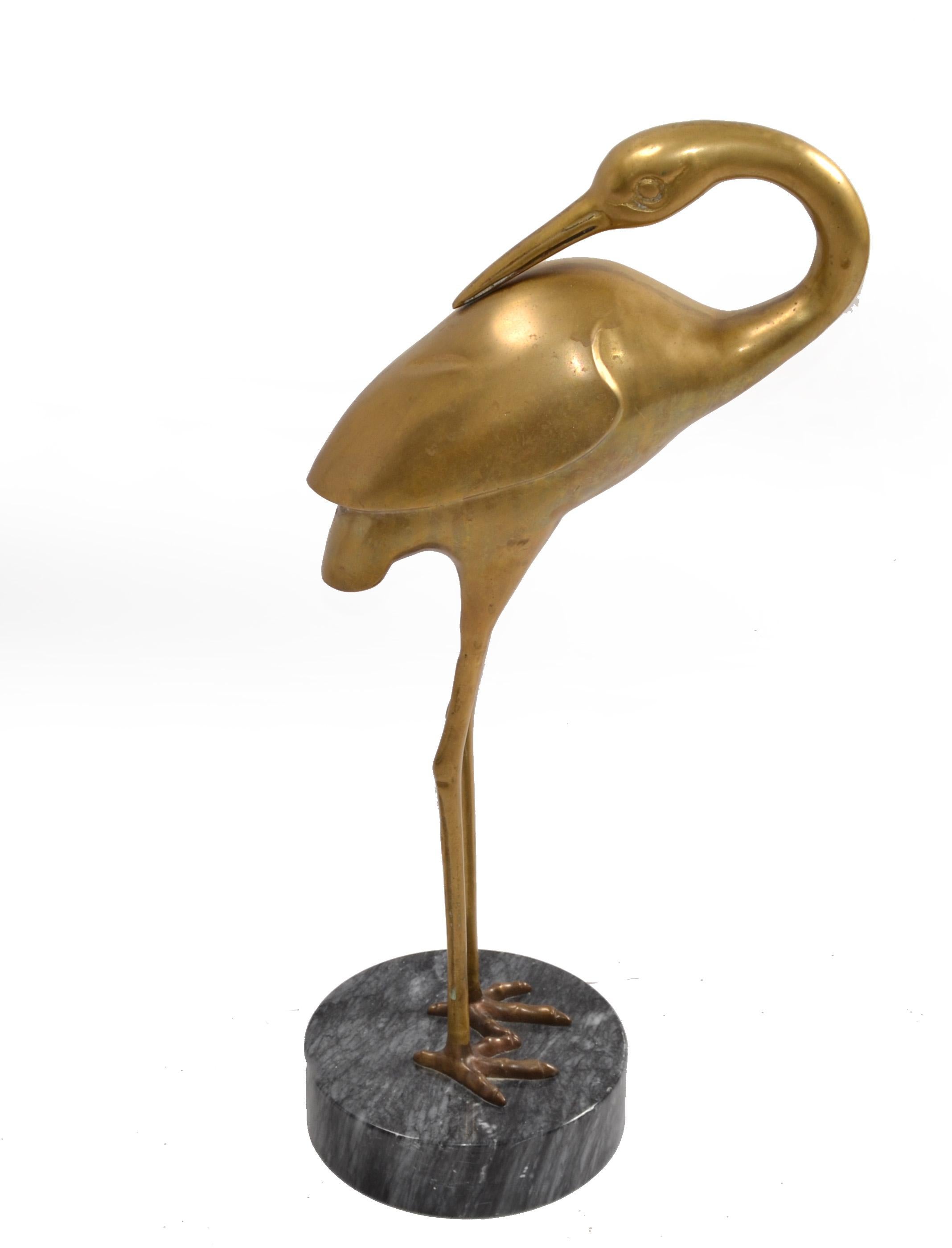 Vintage Bronze Asian inspired Crane or Heron Animal Sculpture on a round black Marble base.
Cranes have been used throughout design for ages because of their unique form and are considered lucky in Asia.
In good vintage condition, some scratches at