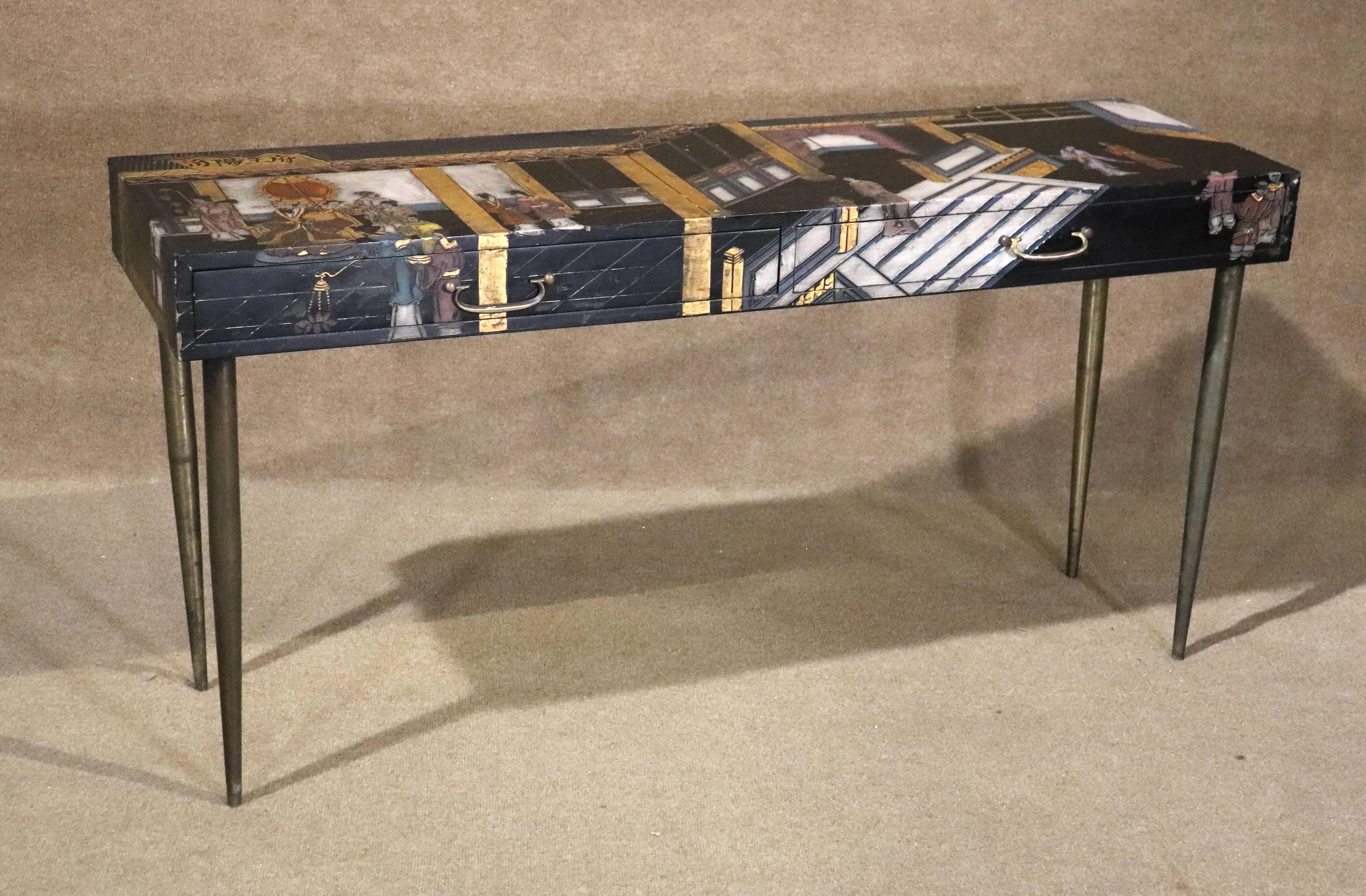 Long lacquered table with etched Asian motif on top and sides. Beautiful imagery and decoration. Set on long brass legs.
Please confirm location NY or NJ