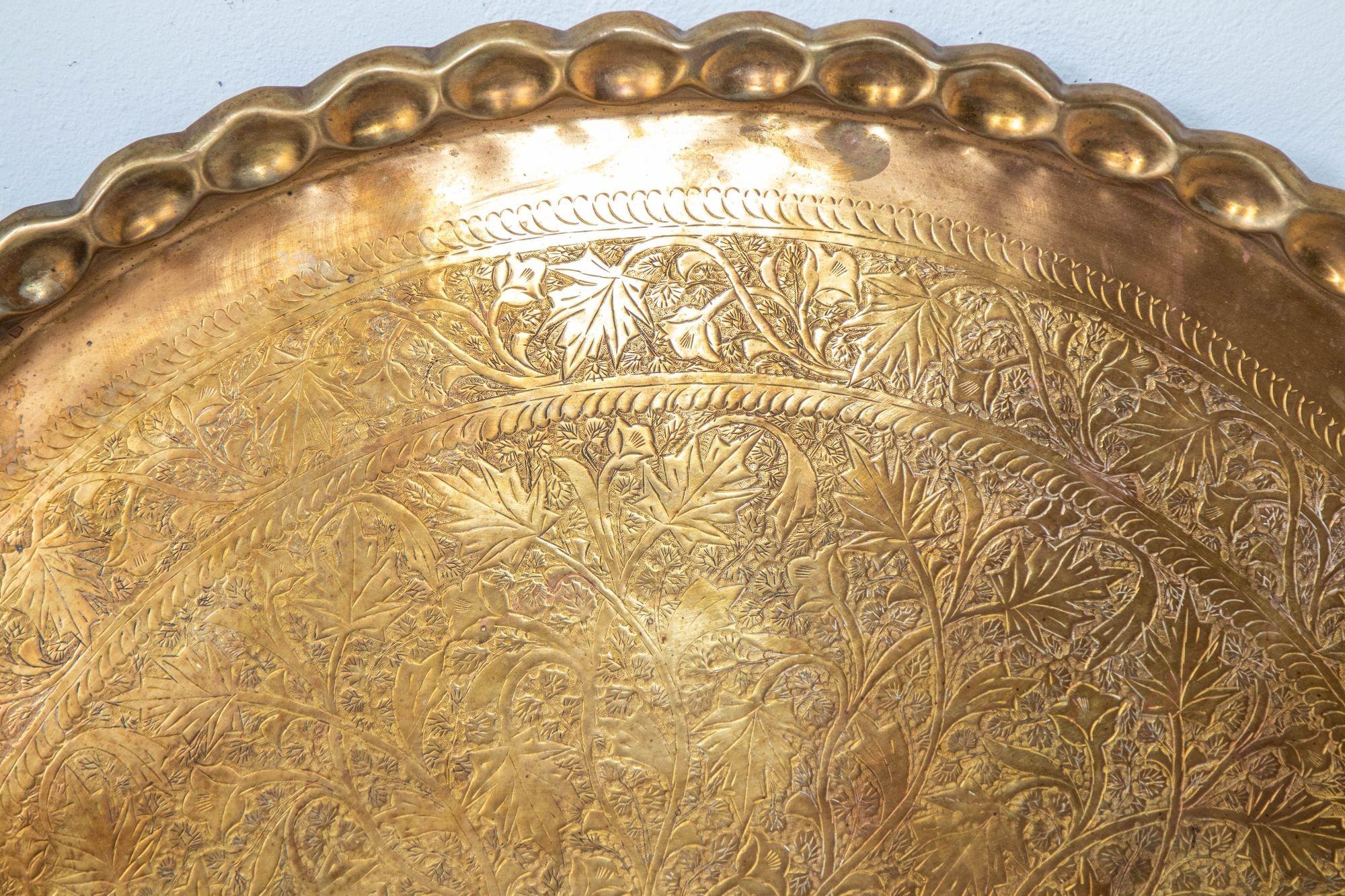 Asian Antique Mughal Rajasthani Large Polished round Brass Tray with crest edges, 37 inches in diameter.
Rare find, large antique brass tray 37 inches diameter finely engraved and hammered with floral Mughal Rajasthani Moorish designs.
Museum