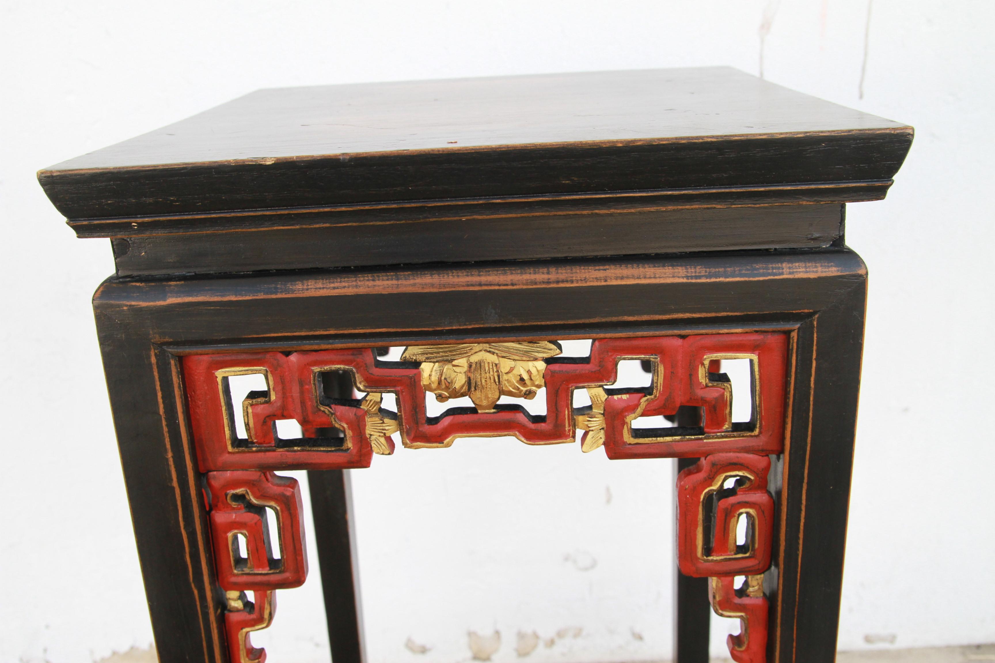 A Chinese Qing Dynasty period side table with single drawer from the 19th century, with horse hoof legs, cinnabar underglaze and distressed patina. Created in China during the Qing Dynasty, this side table features a rectangular top sitting above an