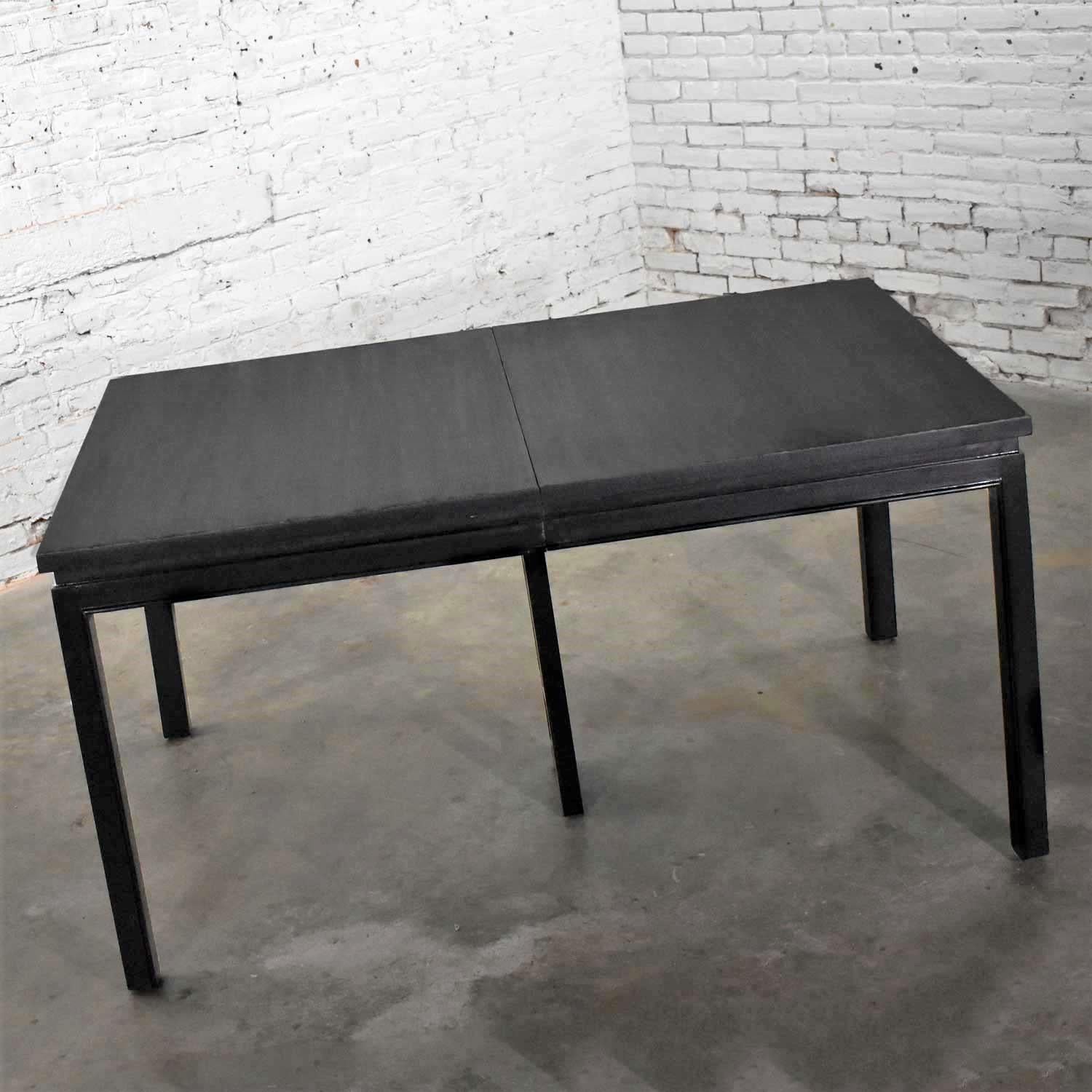 Handsome Asian Parson style extension dining table with a black dyed finish and two aproned leaves. This is a vintage Grand Rapids Bookcase and Chair Company table that we have refinished to a beautiful black. It is in ready to use condition. Please
