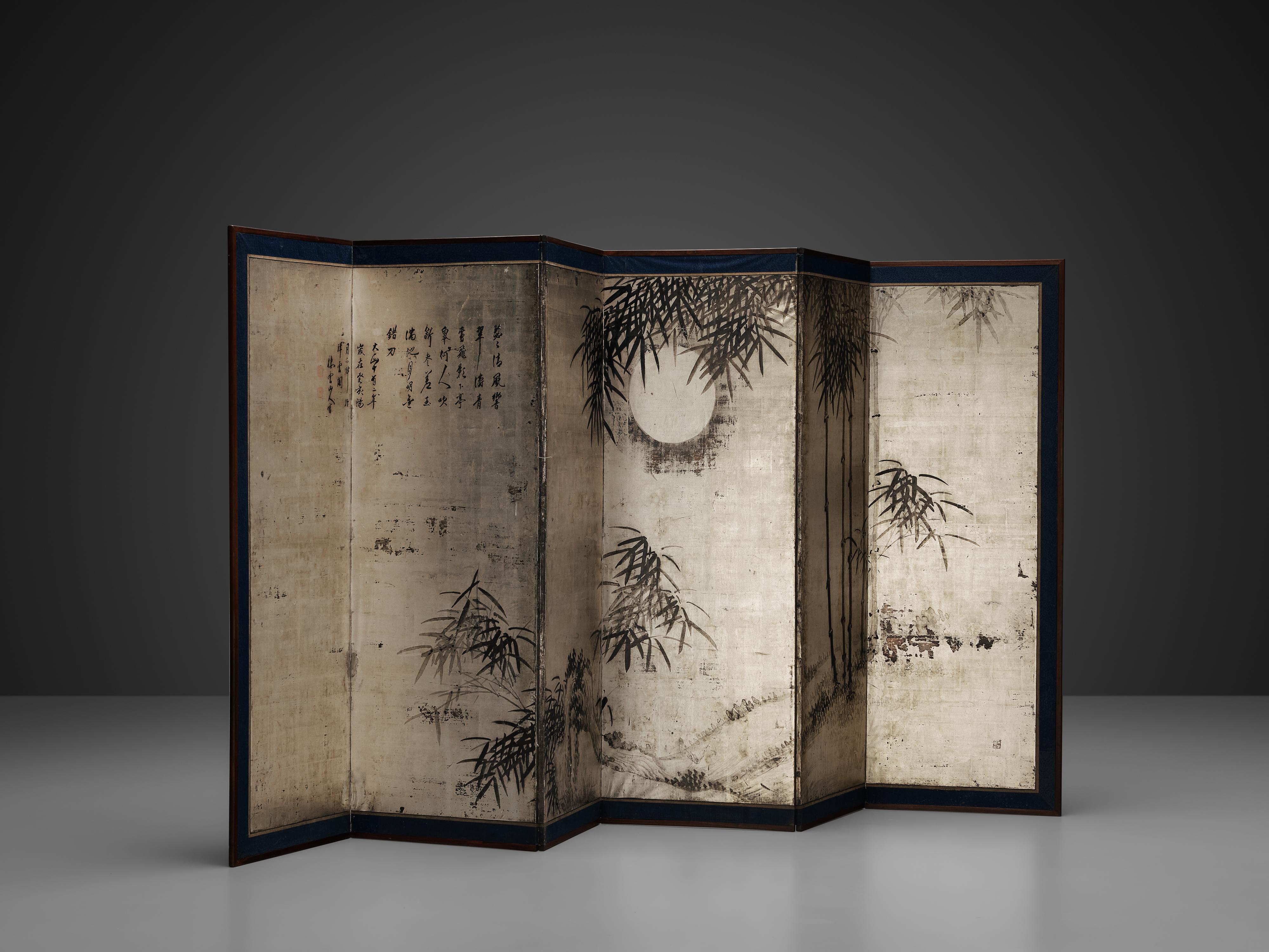 Room divider/screen, wood, parchment paper, paint, Europe, 1970s

Hand painted room divider with floral motifs and Japanese 'Shodo' characters. A nature scene with bamboo plants and a sun or moon fills the six panels. The two outer parts on the left