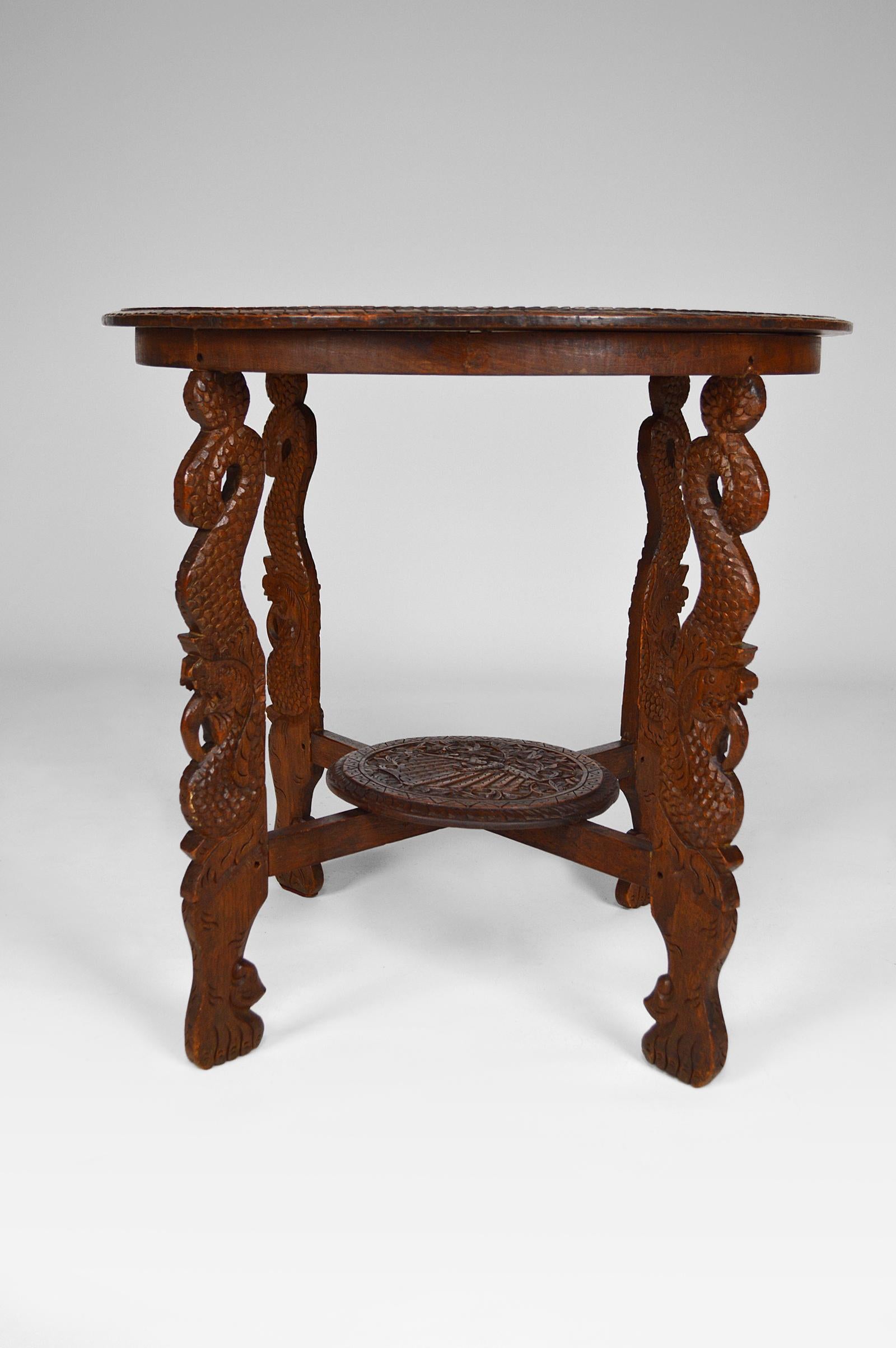 Early 20th Century Asian Round Coffee Table Carved with Dragons and Peacocks, Indonesia, circa 1920 For Sale