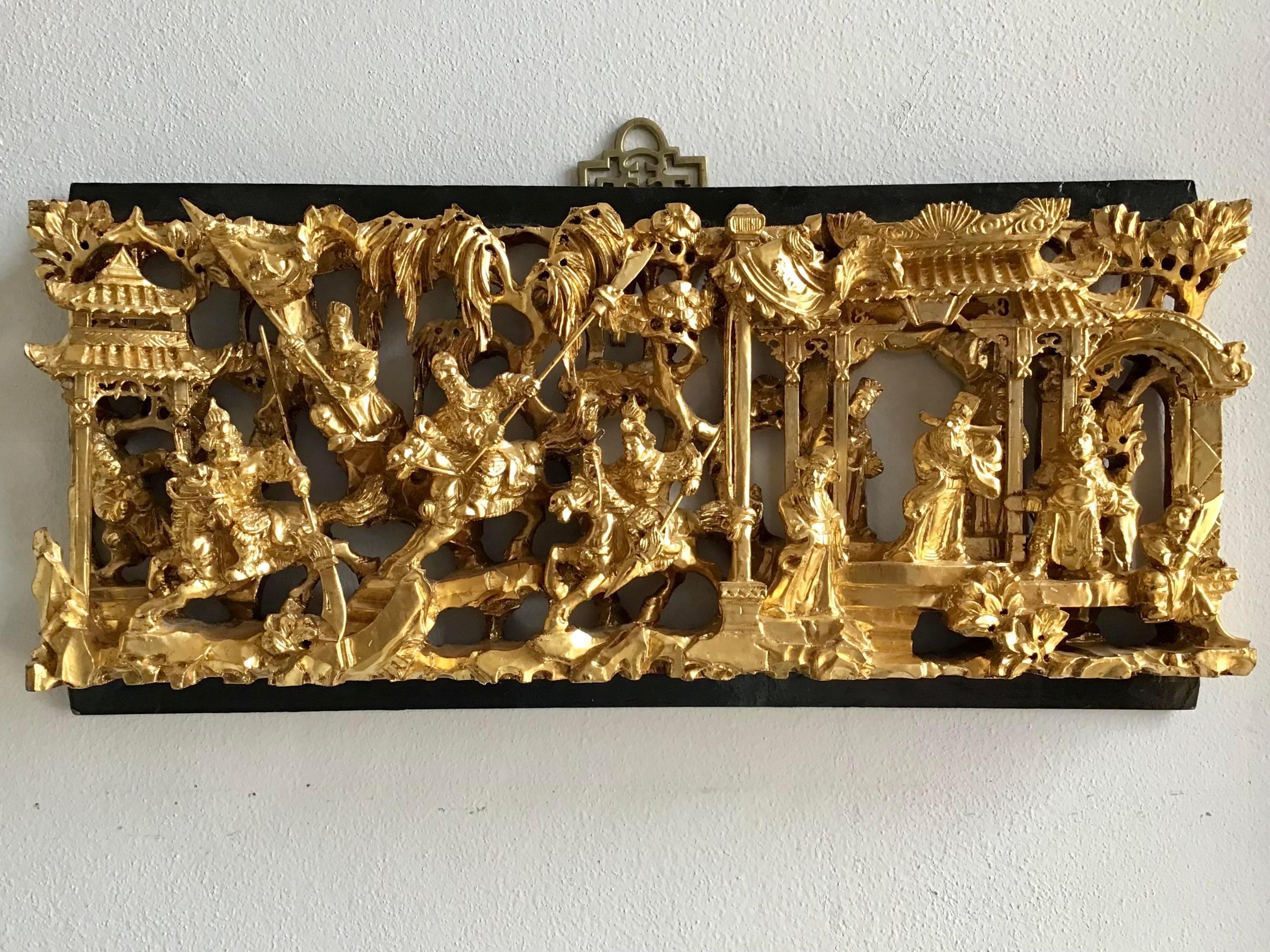 Beautiful rectangular wall piece of an Asian scene carved on wood. Great details painted in gold.
