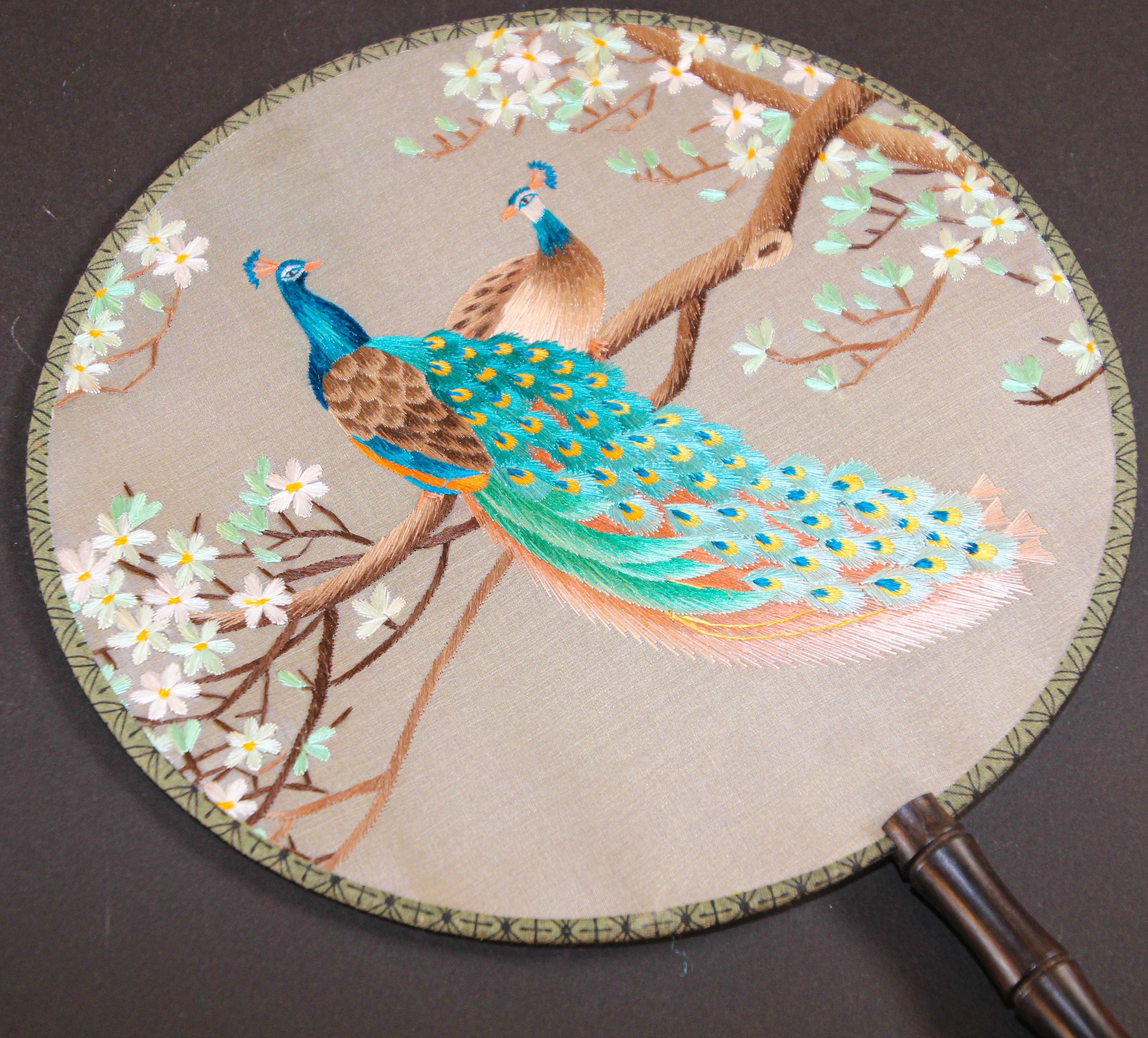 Asian Chinese silk round paddle fan, hand fan with two peacocks perched on a tree embroidered.
Vintage Asian hand fans decorated with with peacocks embroidered.
Chinoiserie silk paddle fan with with peacocks embroidered designs in both sides,