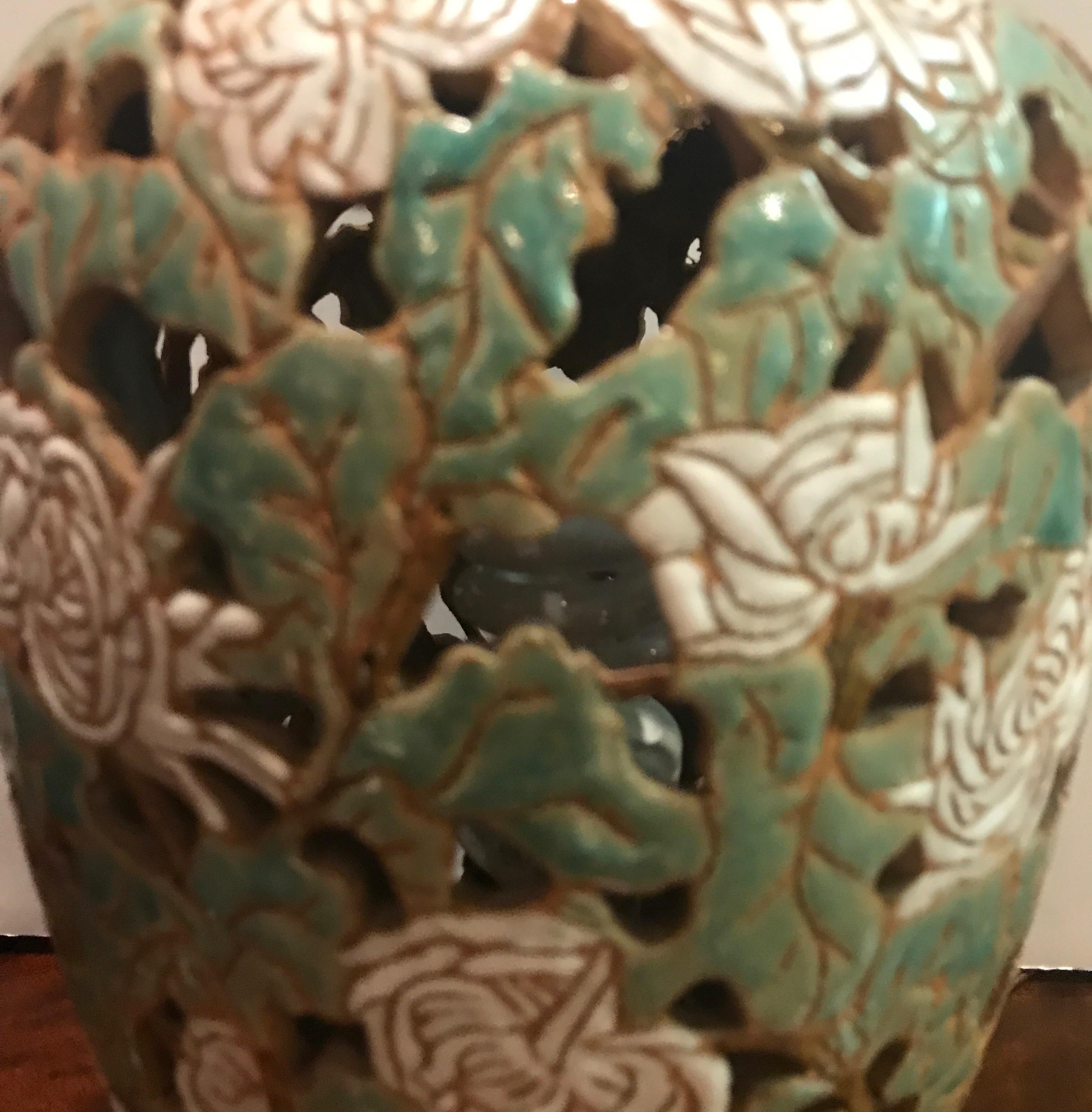 Asian style is pottery lamp with reticulated body. The ginger jar form with hand enameled peony floral decoration, circa 1930s and high style that compliments a modern or traditional interior.