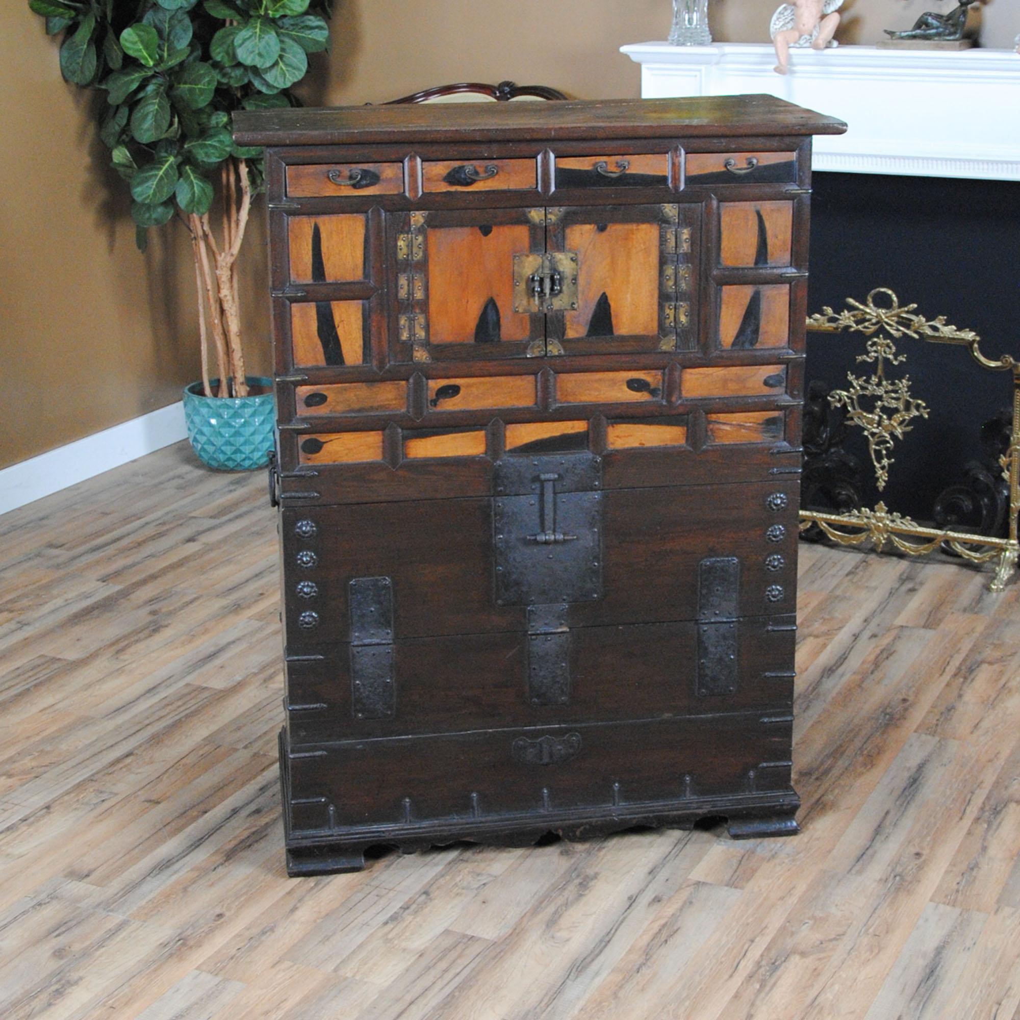 A most unusual and interesting Asian Style cabinet. Compact in size this piece appears to be quite old but is in very good condition. The use of different and varied types of woods gives the cabinet a lot of charm and eye appeal and the drawers and