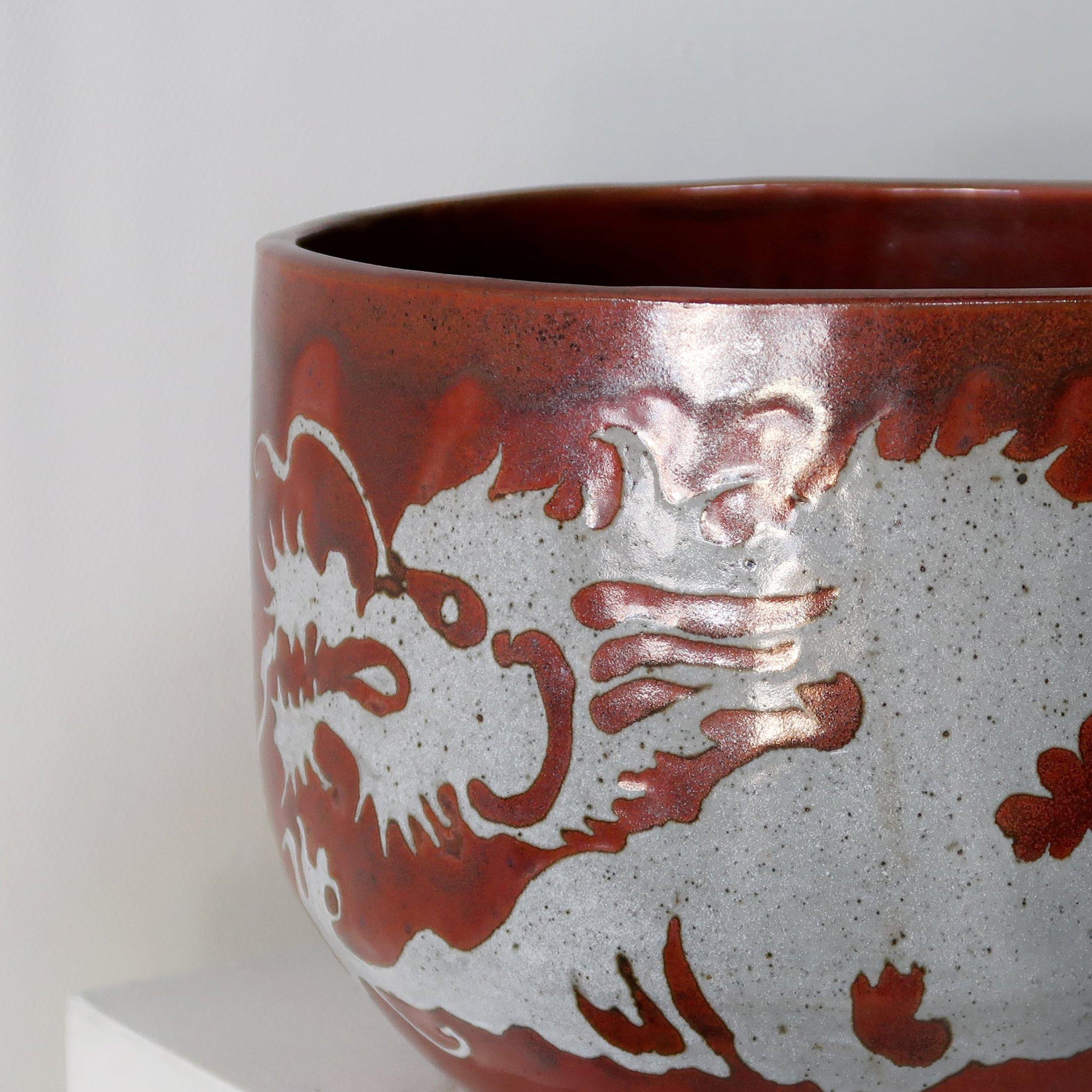Asian style ceramic pot by Gay Schempp in striking maroon and adorned with intricate gray Asian characters. This unique piece combines artistry and functionality. (Signed)

This pottery piece does not come with a drain hole.

Measures 11.5