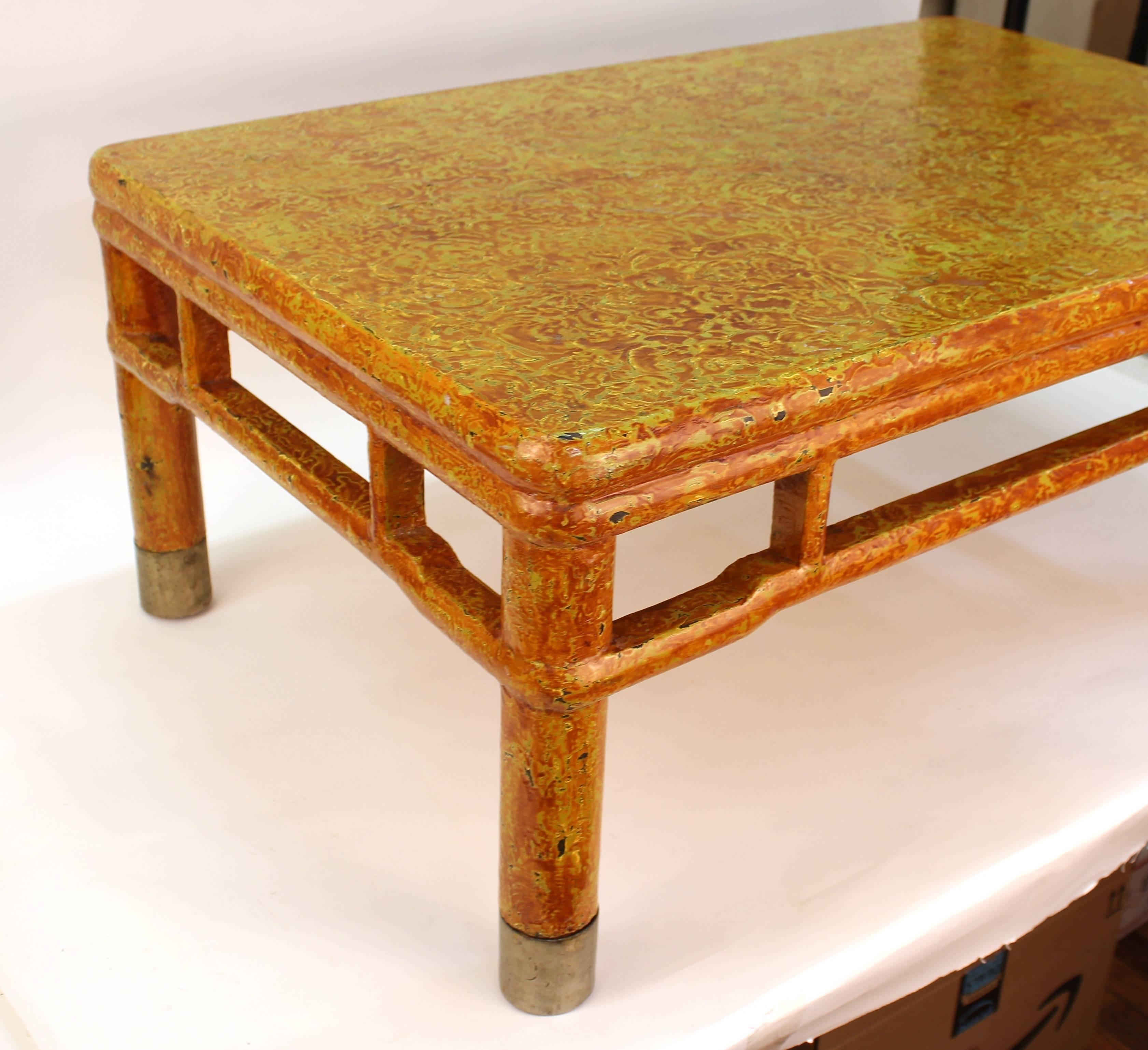 A midcentury Asian Style cocktail or coffee table on four legs with a distinct craquelure aged finish. The piece is in good vintage condition with age appropriate wear.