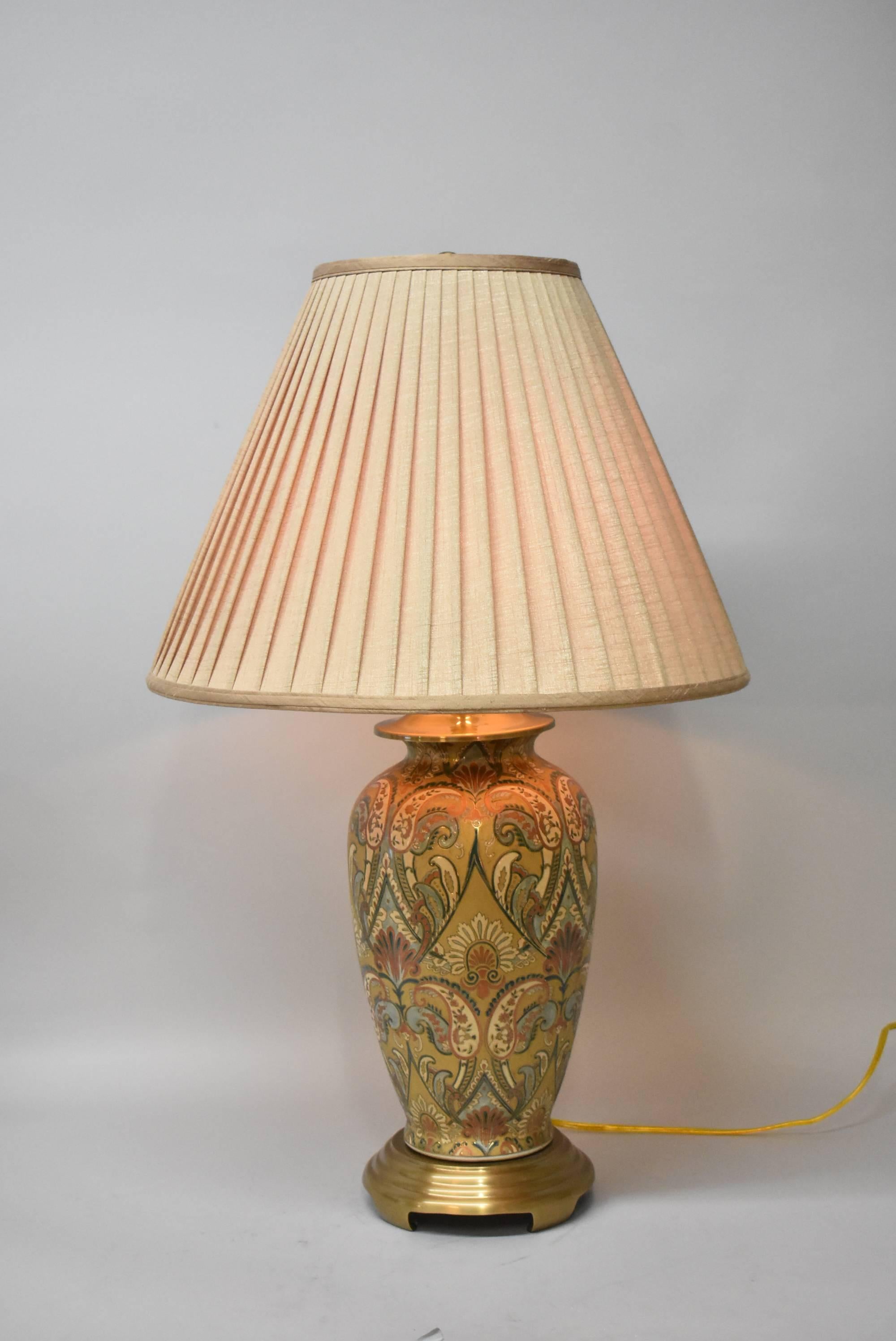 An absolutely beautiful Asian style table lamp by Frederick Cooper. This stunning ginger jar lamp features a paisley design in turquoise, rust, gold and green. There is one socket. The dimensions are 32