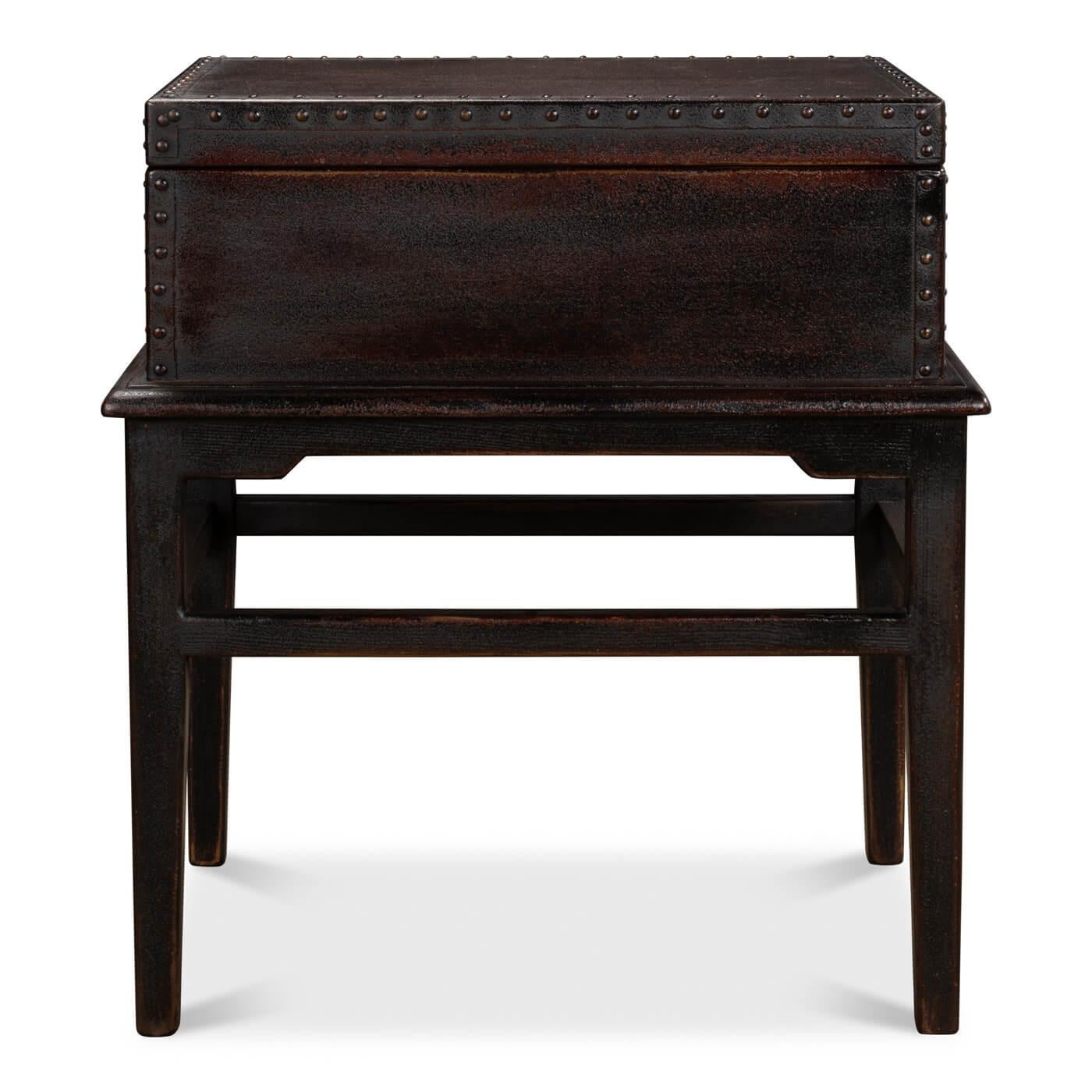 An Asian style leather box on stand table. The rectangular box with a removable lid is covered in leather with nailhead trim. It sits on a reclaimed pine base in a 
