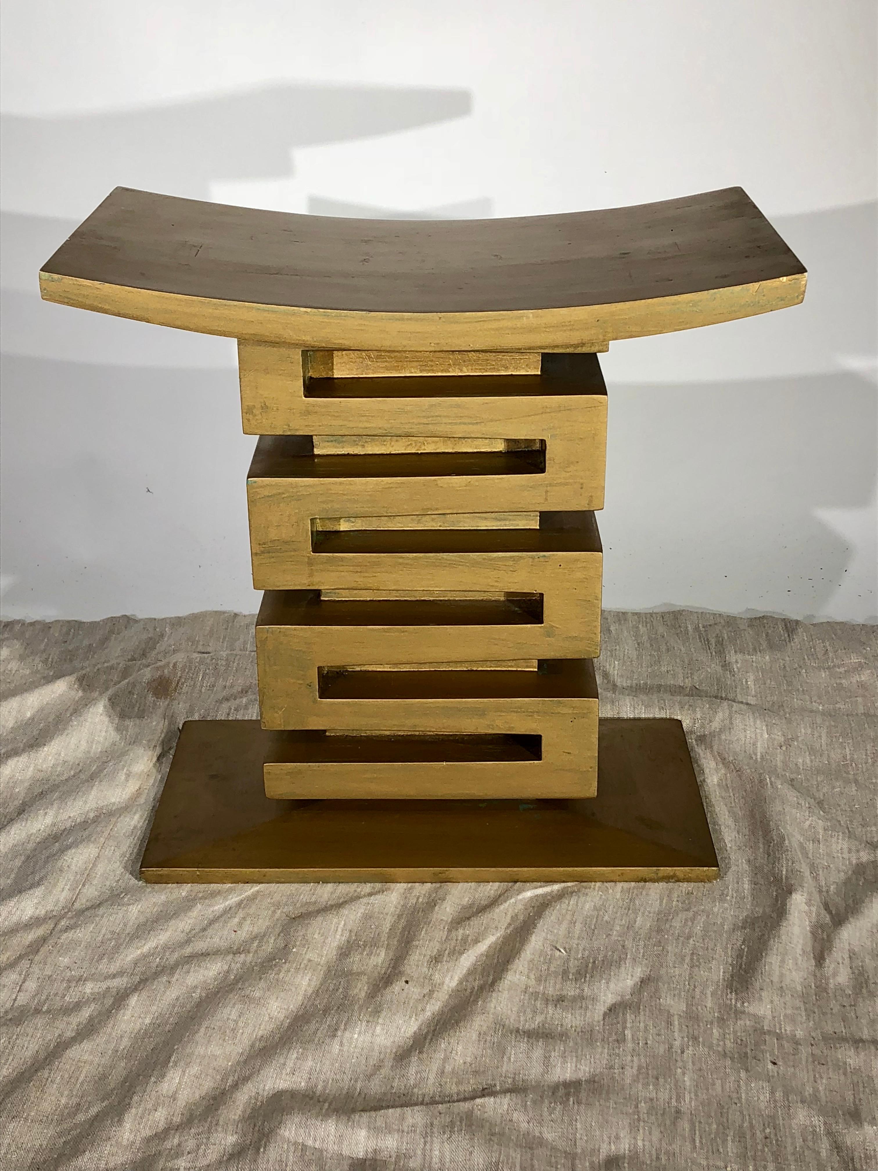 A Mid-Century Modern Asian inspired tabouret in cast stucco with a gold finish. In the style of James Mont, circa 1950.