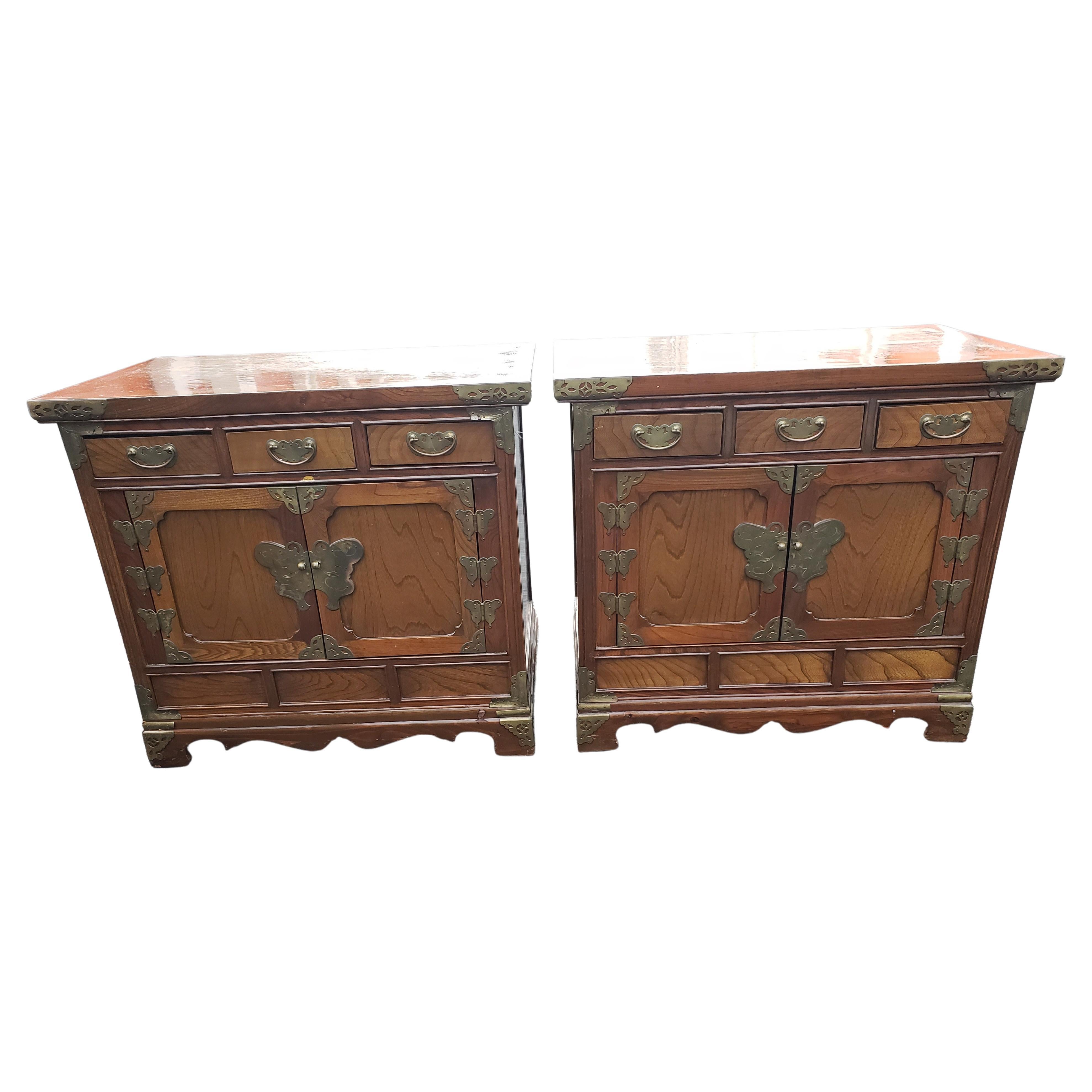 1932 Asian Tansu style Campaign nightstands. Made of Walnut Burl wood and decorated with Brass Fittings. These versatile pieces are great storage cabinets in the bedroom and well as side tables in the family or living room. They are very light