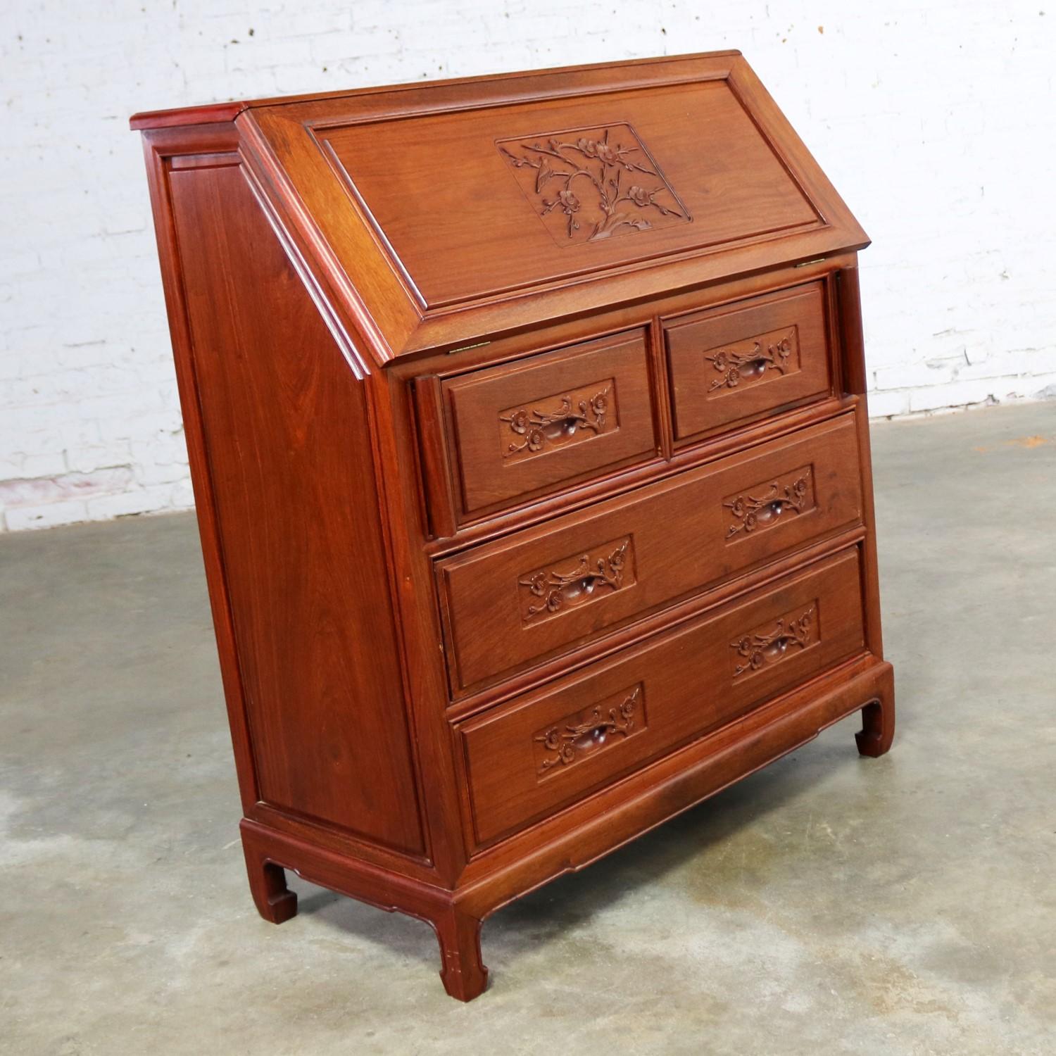 Handsome Asian teak hand carved drop slant front desk with interior compartmentalized cubby storage in the style of George Zee and Co. of China. This amazing piece is in fabulous condition. Please see photos, circa mid-20th century.

This