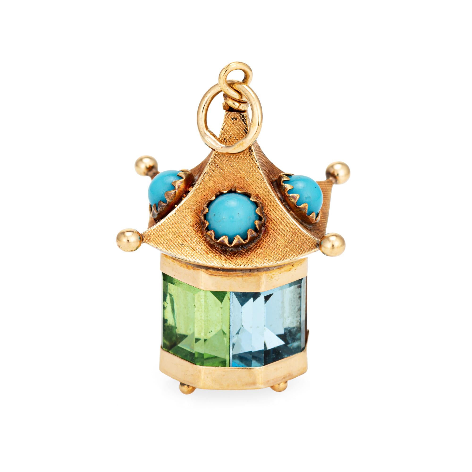 Finely detailed vintage temple charm crafted in 14k yellow gold (circa 1960s to 1970s).  

Cabochon cut turquoise measures 4mm diameter. Blue topaz, peridot, amethyst & citrine measures 10mm x 7mm (in very good condition and free of cracks or