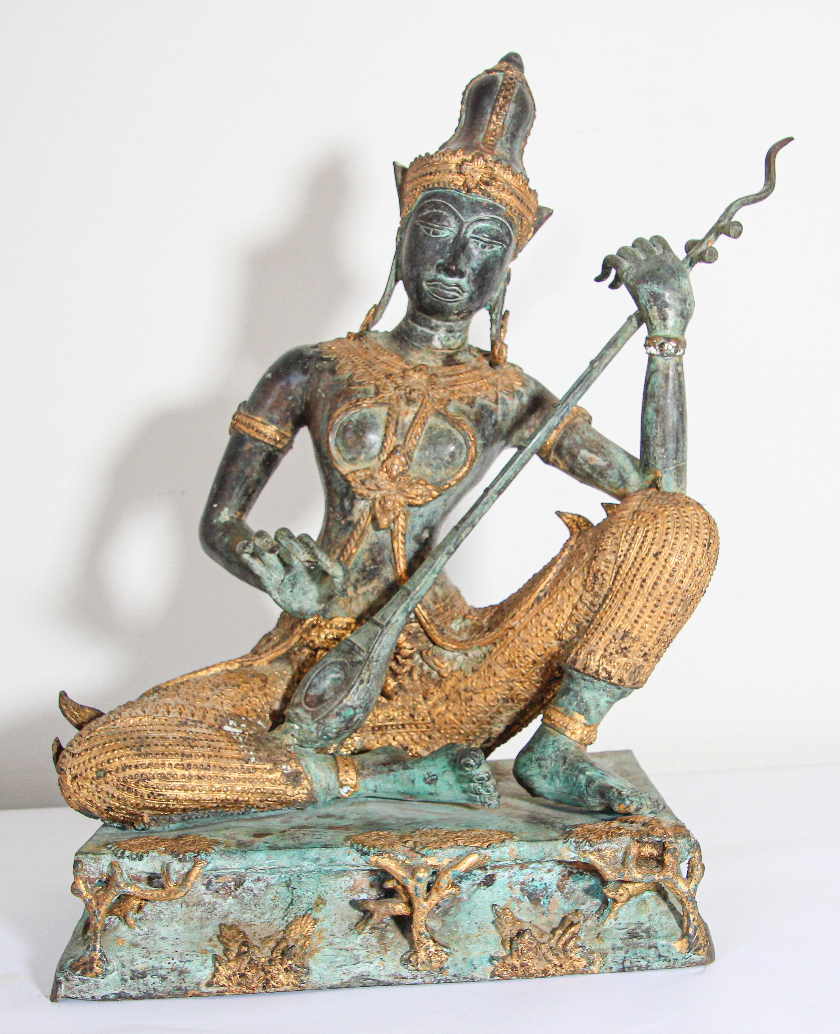 Large vintage heavy bronze statue of Prince Pra Apai Manee playing a traditional Asian string instrument called 