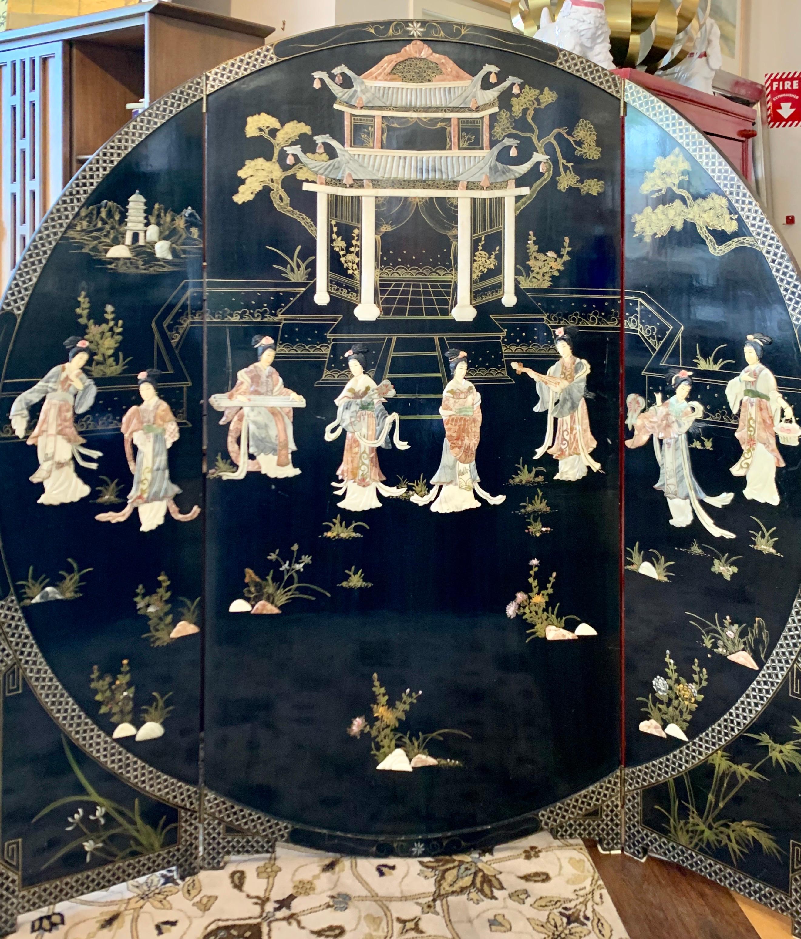 A Chinese export round black lacquer screen with molded hardstone figures , pagoda and gold painted oriental landscape.

The side pieces fold in and measure eighteen inches each and the center piece measures thirty six inches wide. When it is fully