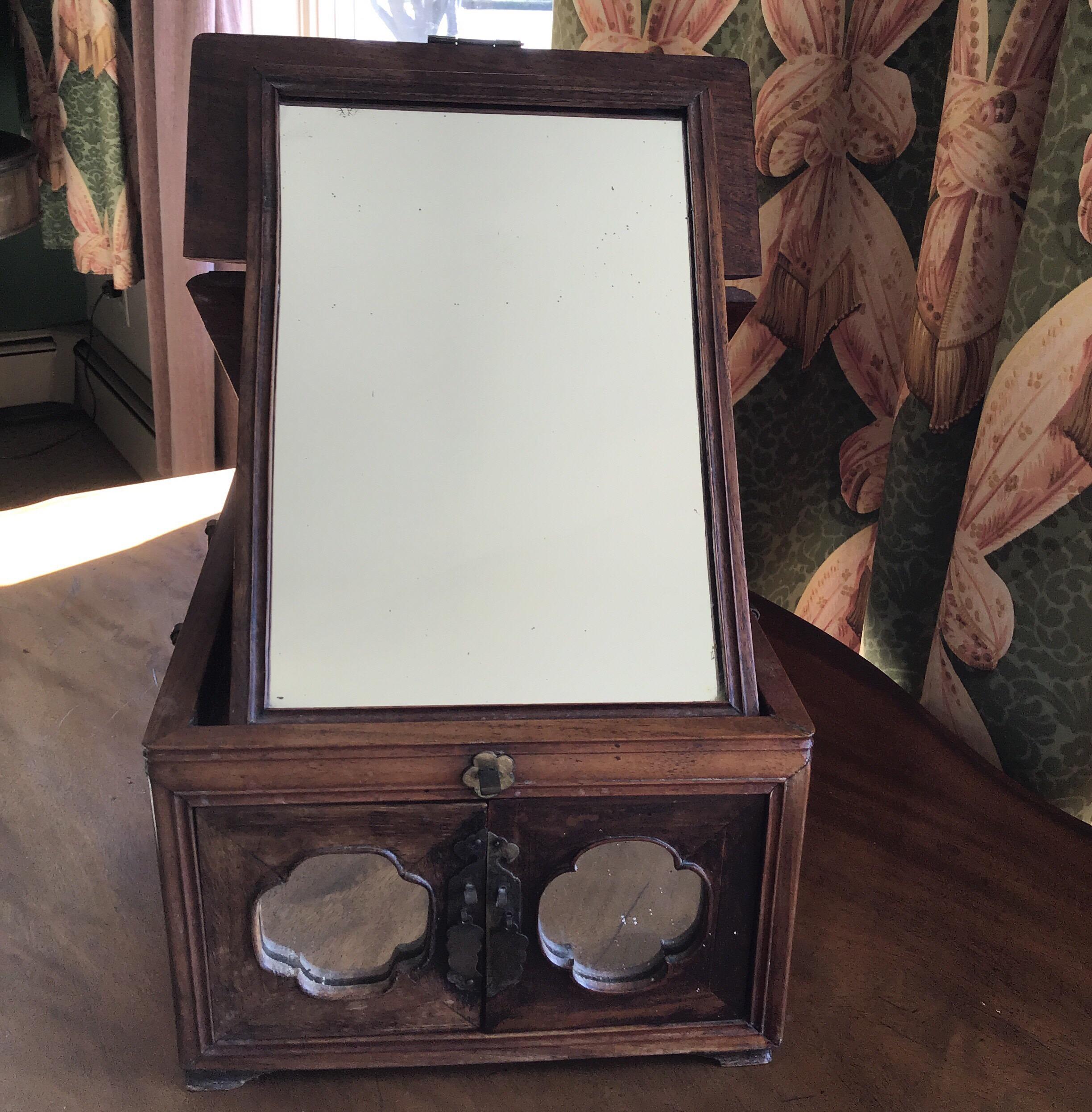 Mirrored traveling makeup /jewelry case with silvered butterfly hinges.