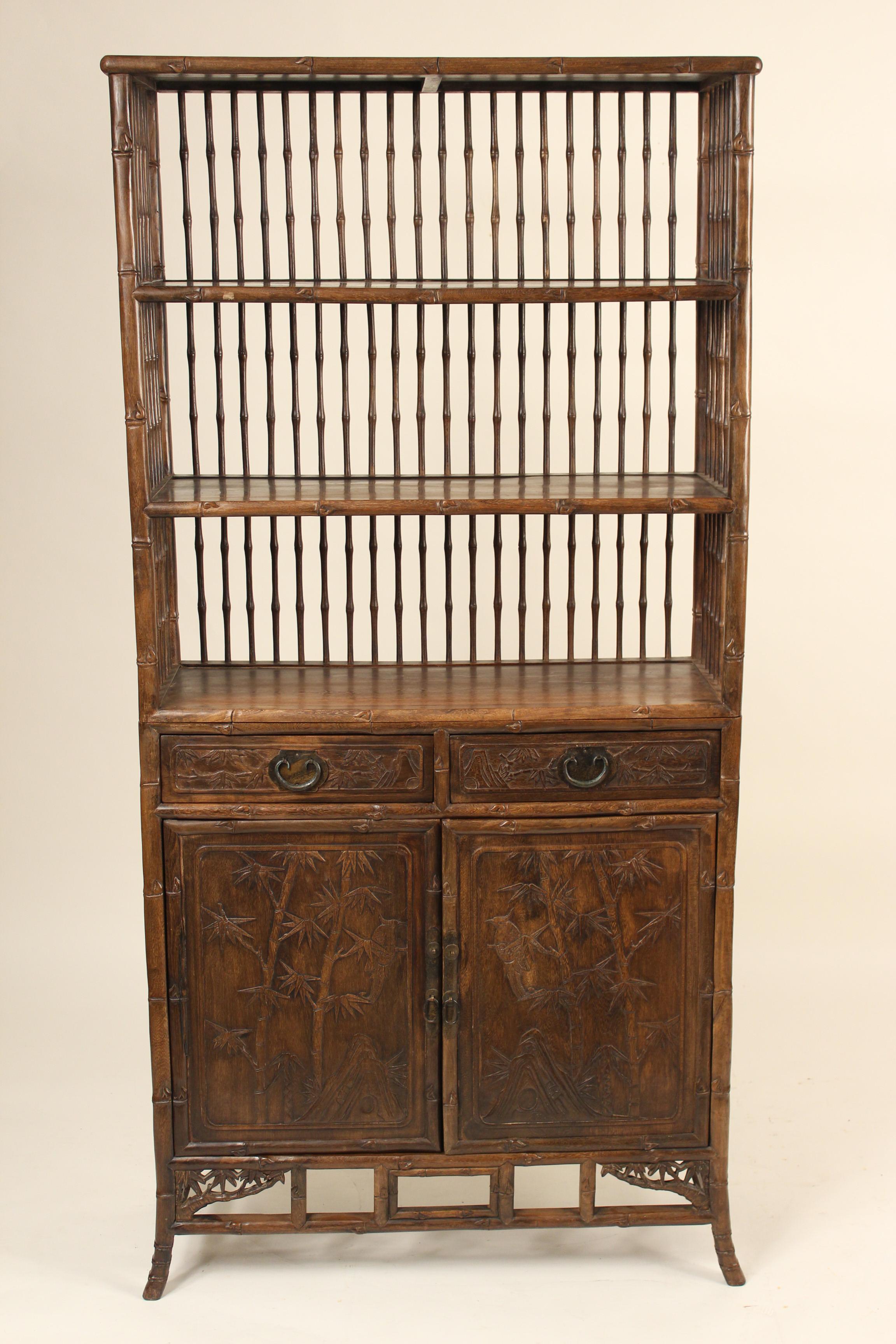 Asian carved two part bookcase, circa 1980s. The width measured from the front feet is 35