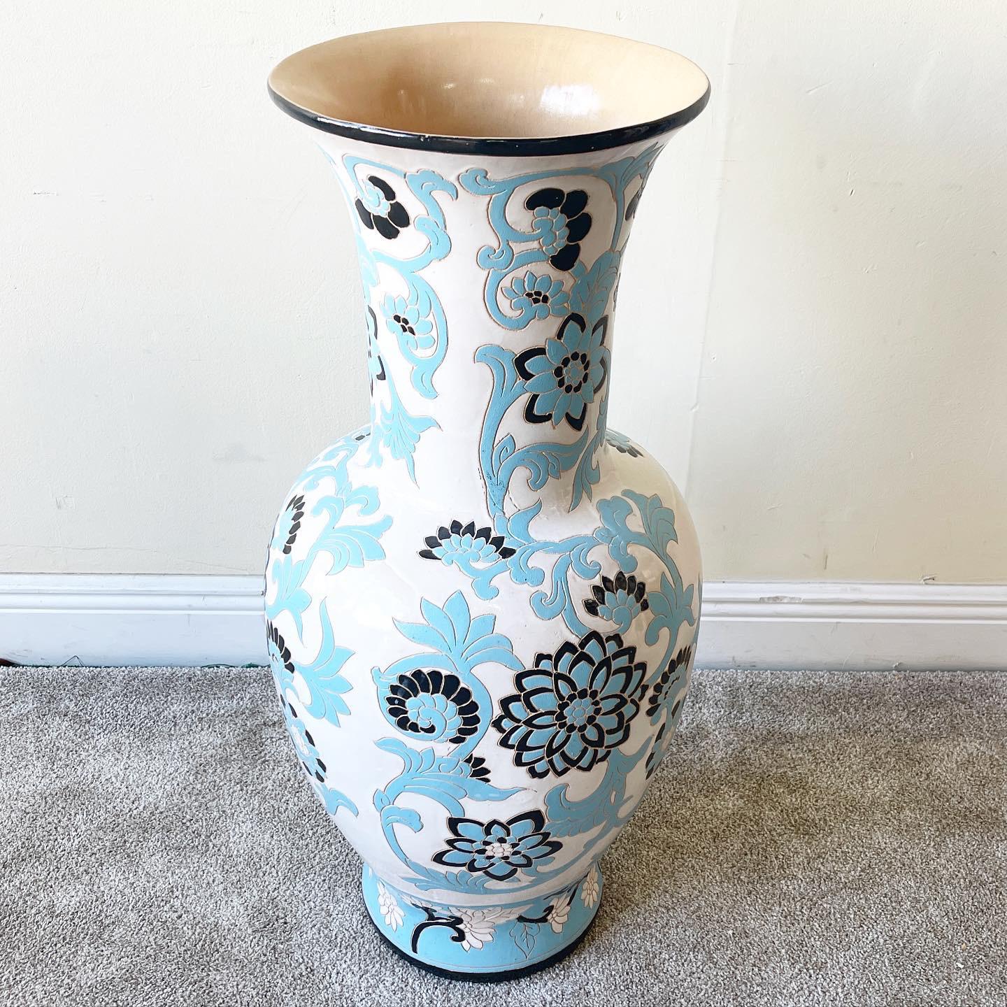 Incredible pottery floor vase. Glossy black and blue lotus flowers erupt over a white backdrop.
 