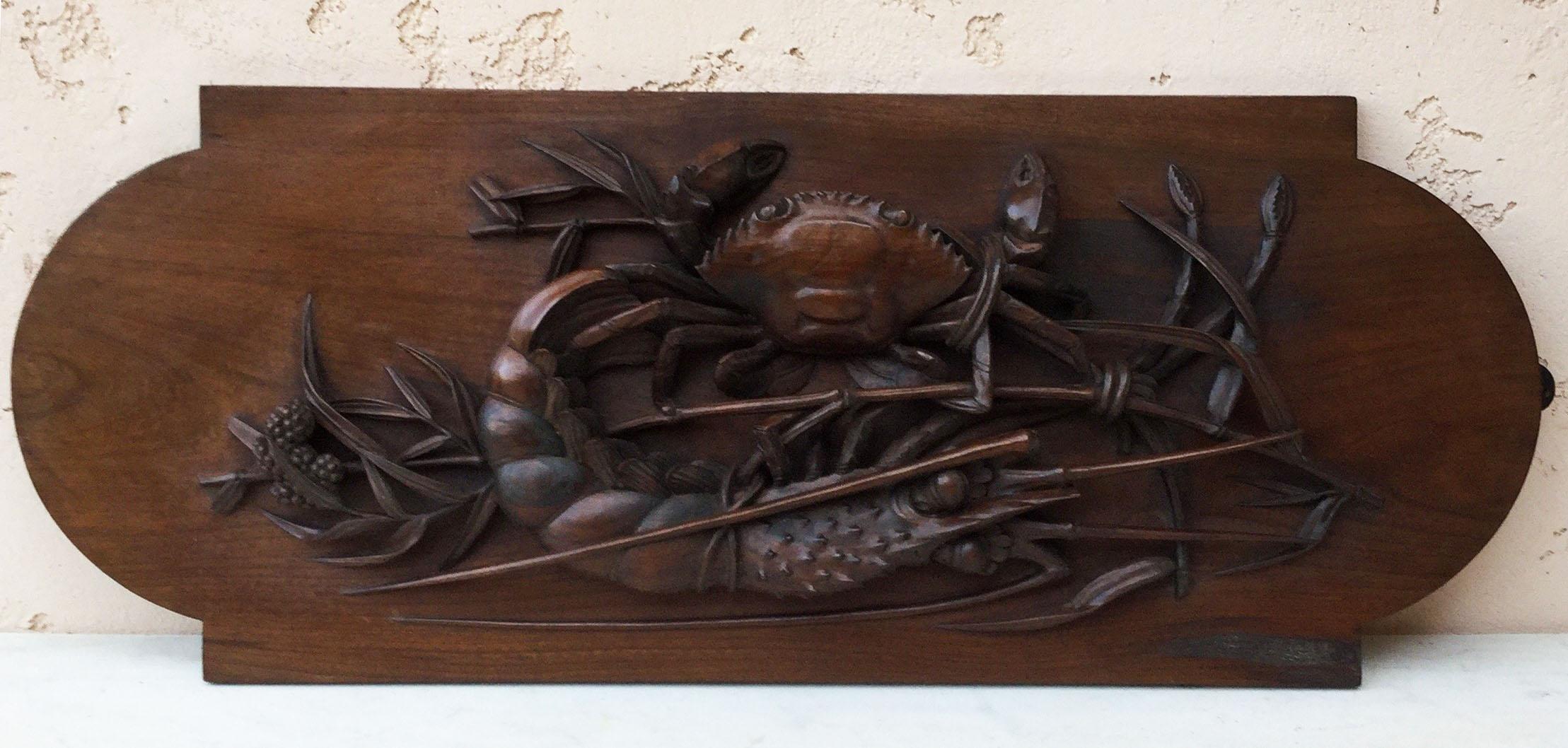 An Asian fine carved wood wall plaque possibly Japonese with a crab, a lobster on bamboo.