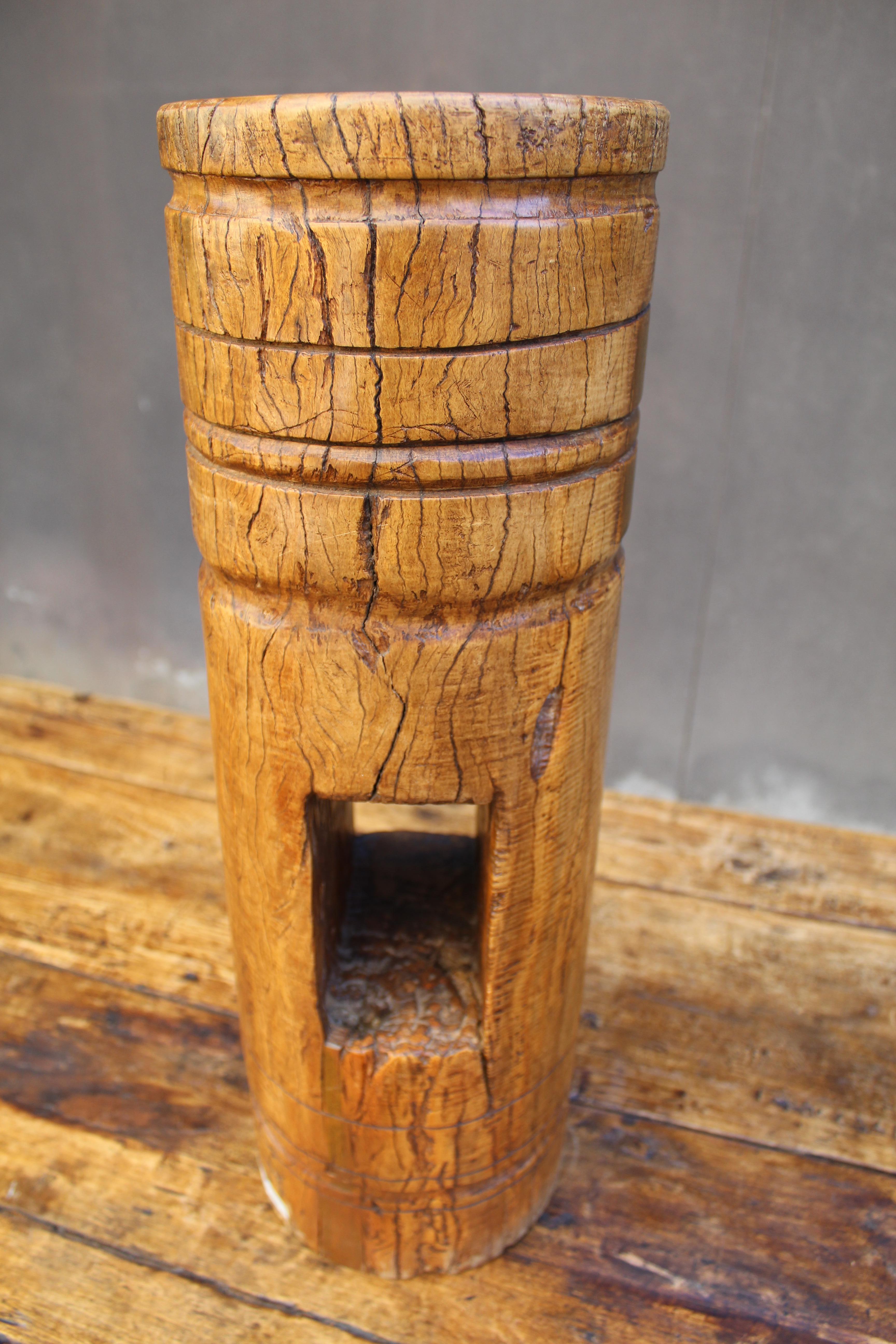 Asian wood house piling. Hand hewed pole, you can see the mortise joint indicative of Asian traditional architectural craftsmanship for timber-framed structures embodies a heritage of wisdom and craftsmanship. Found Object or drink stand.