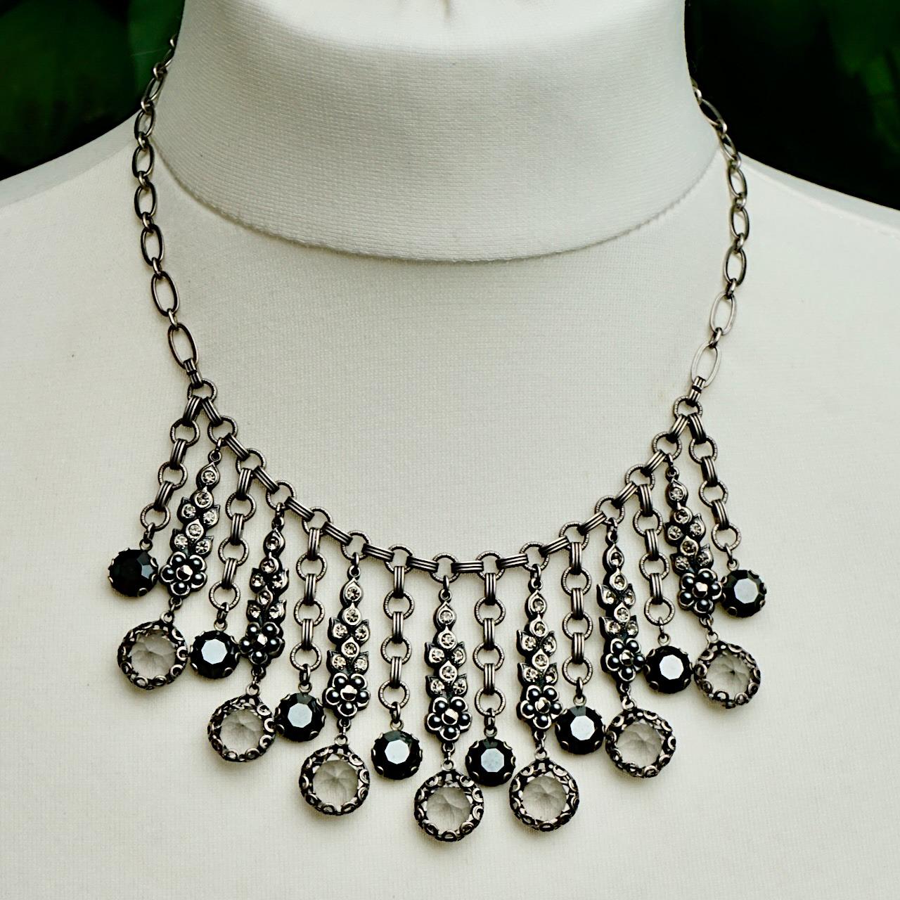 
Fabulous Askew London detailed antiqued silver tone necklace, featuring fifteen drops set with marcasites, grey pearls and rhinestones. It has a hook clasp set with rhinestones. Measuring necklace length 47.8 cm / 18.8 inches, and the longest drop