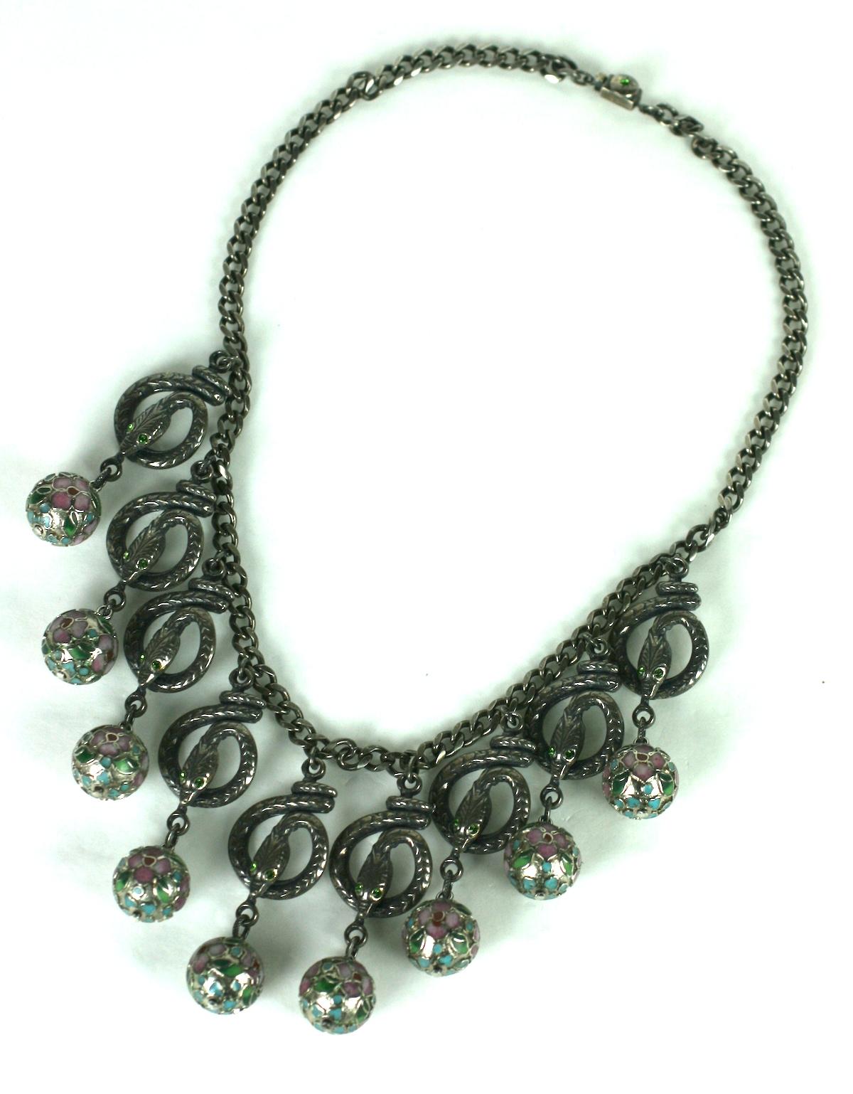 Eygptian Revival Askew London Snake Drop Necklace with enamel cloisonne beads in pale pinks and greens.  Silverplated antique finish. The snakes are set with emerald crystal eyes.
1980's UK.   16