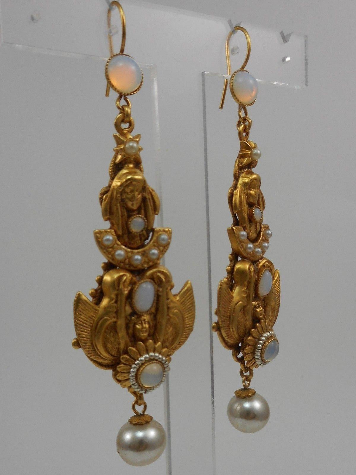 Askew London Winged Goddesses and Maidens, enhanced with Flowers, Pearl Beads and Glass Cabochon stones. Earrings Have Round Pearl Bead Drops and Hook Earring Fittings. Antiqued Filigree Gilt Brass; Earrings measure approx. 3.75'' X 1.00'' Signed: